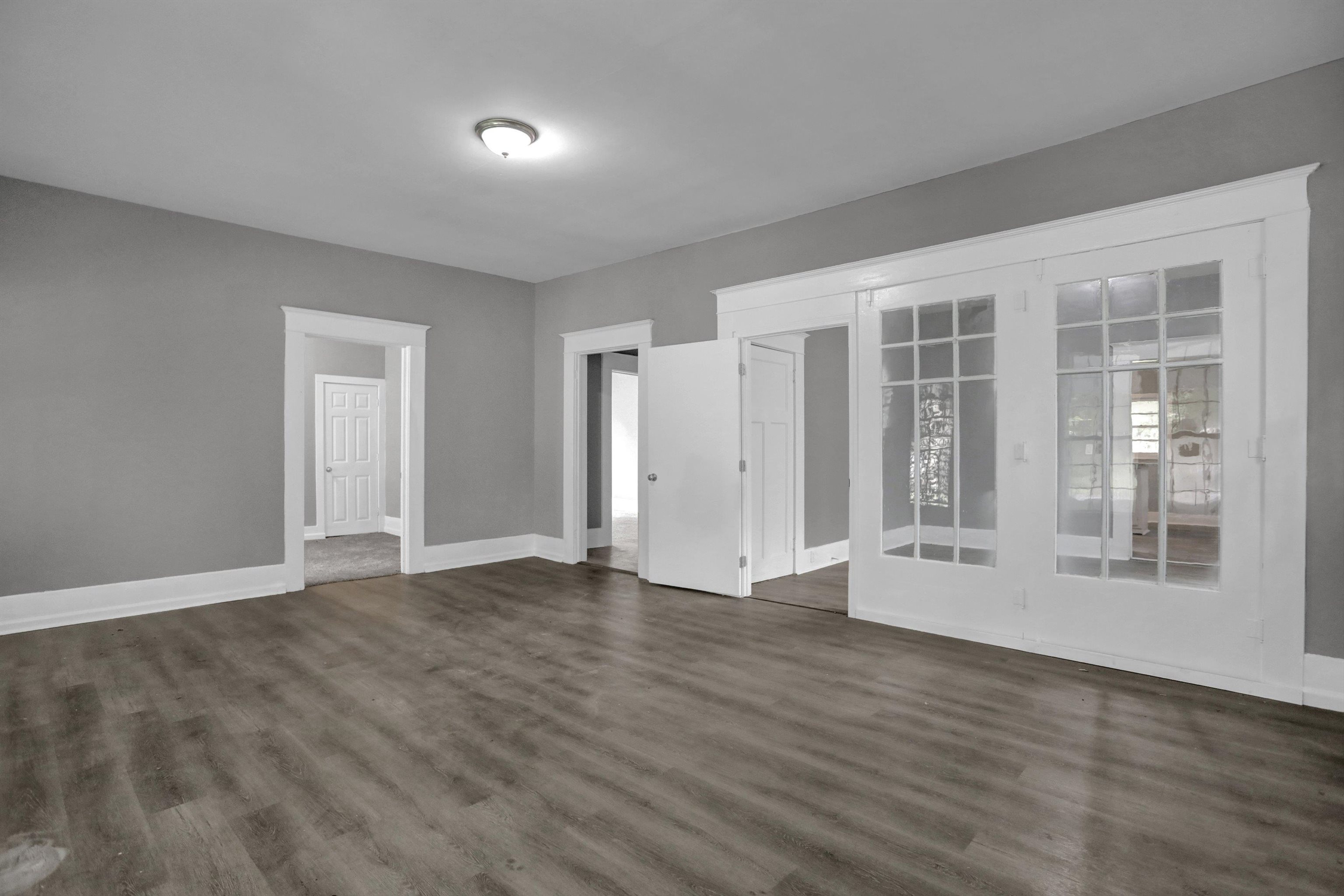 Interior space with french doors and dark hardwood / wood-style floors