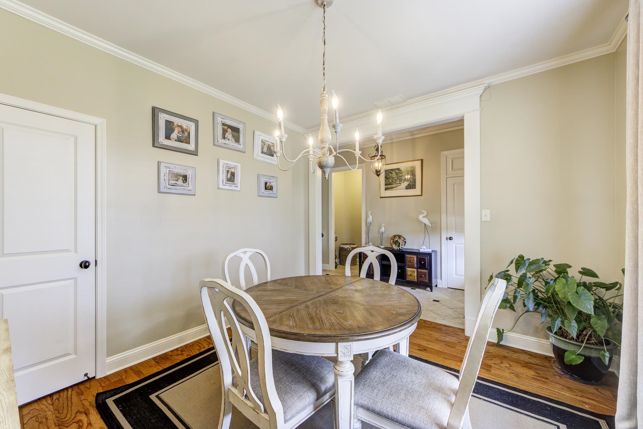 Dining area with a chandelier, REAL hardwood floors, and crown molding, Deep Storage Closet