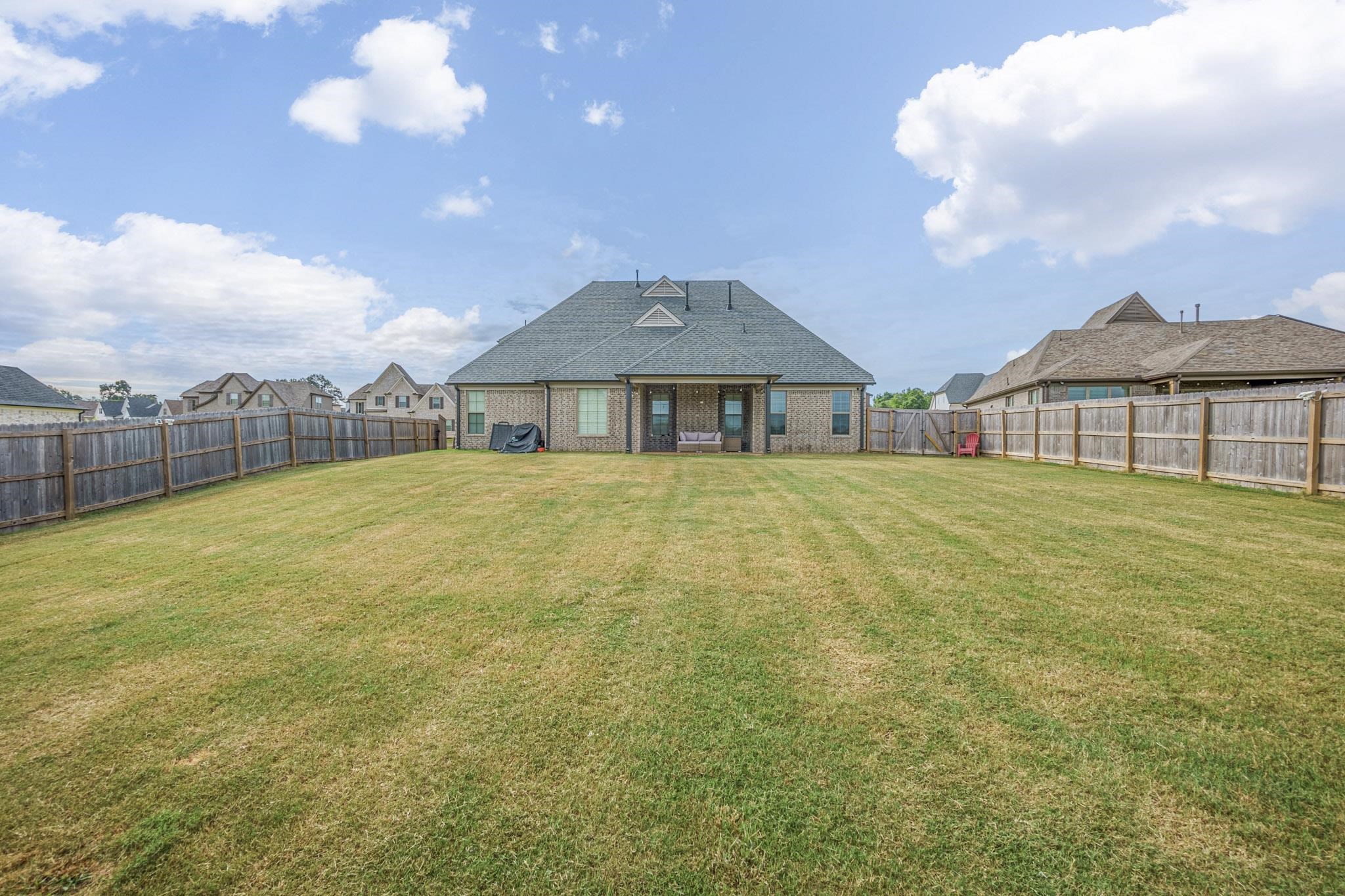 Back of house featuring a yard