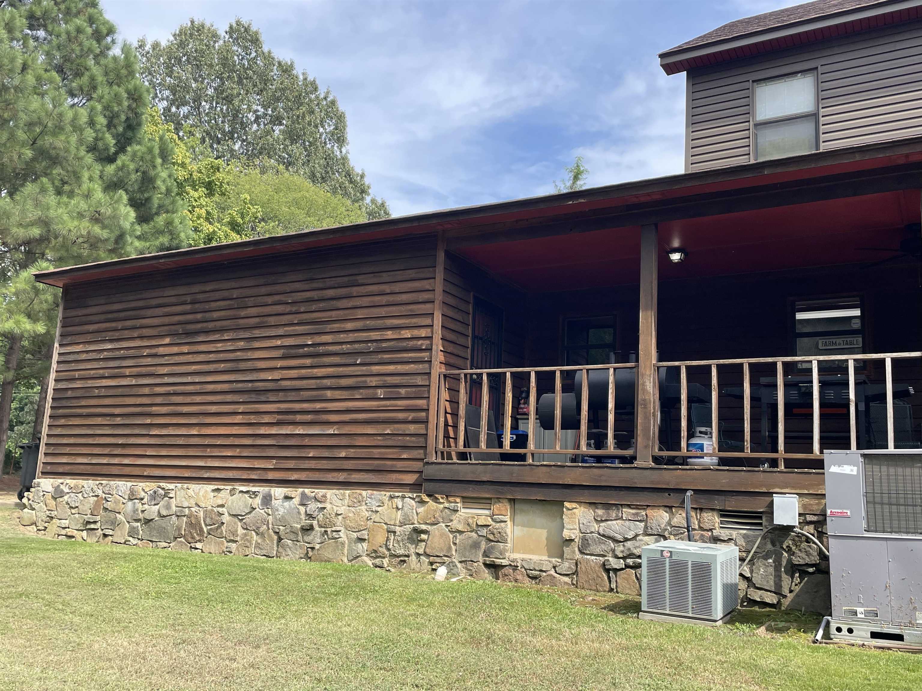 View of property exterior featuring a yard and central air condition unit