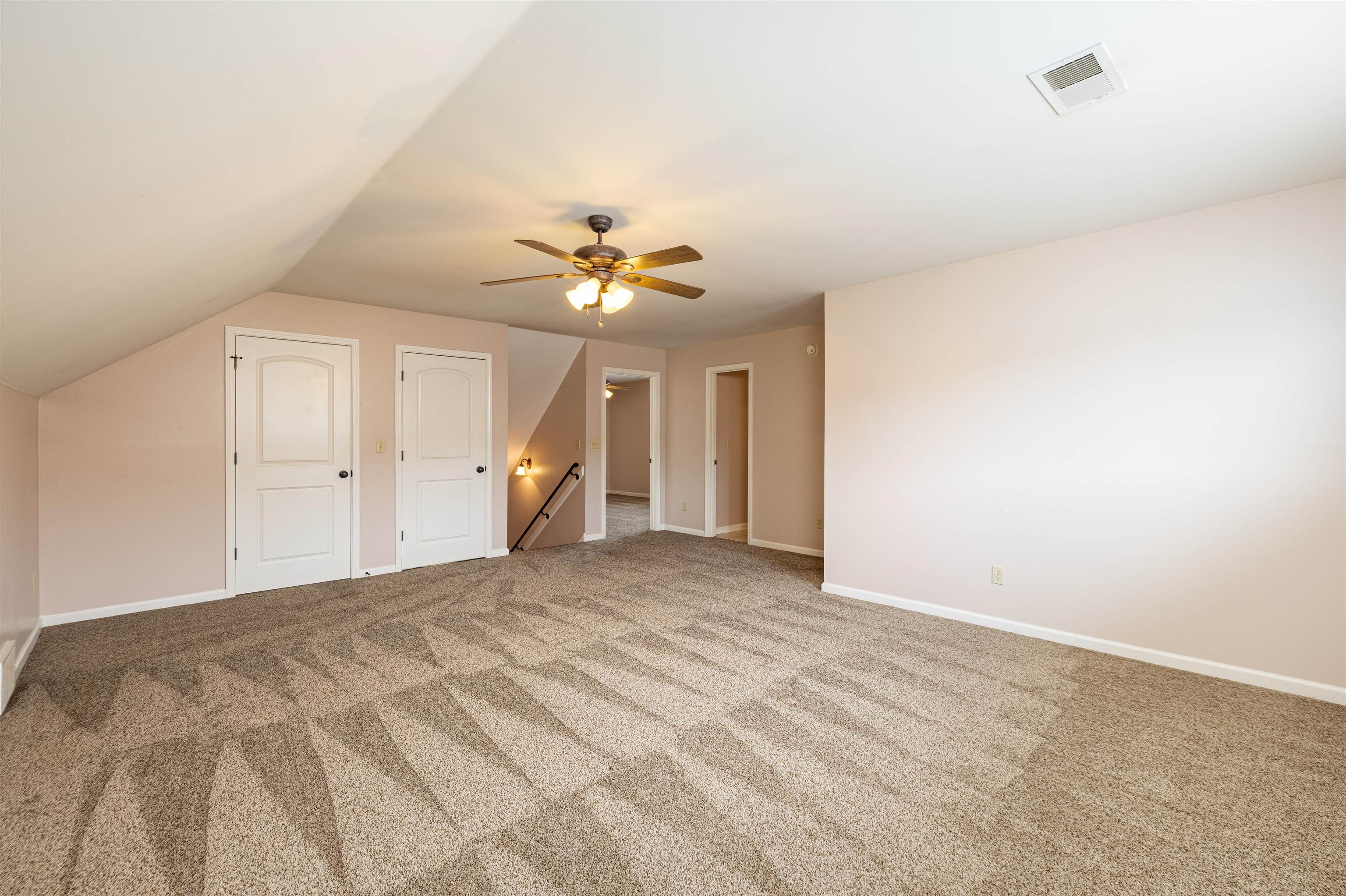 Bonus room featuring lofted ceiling, carpet flooring, and ceiling fan