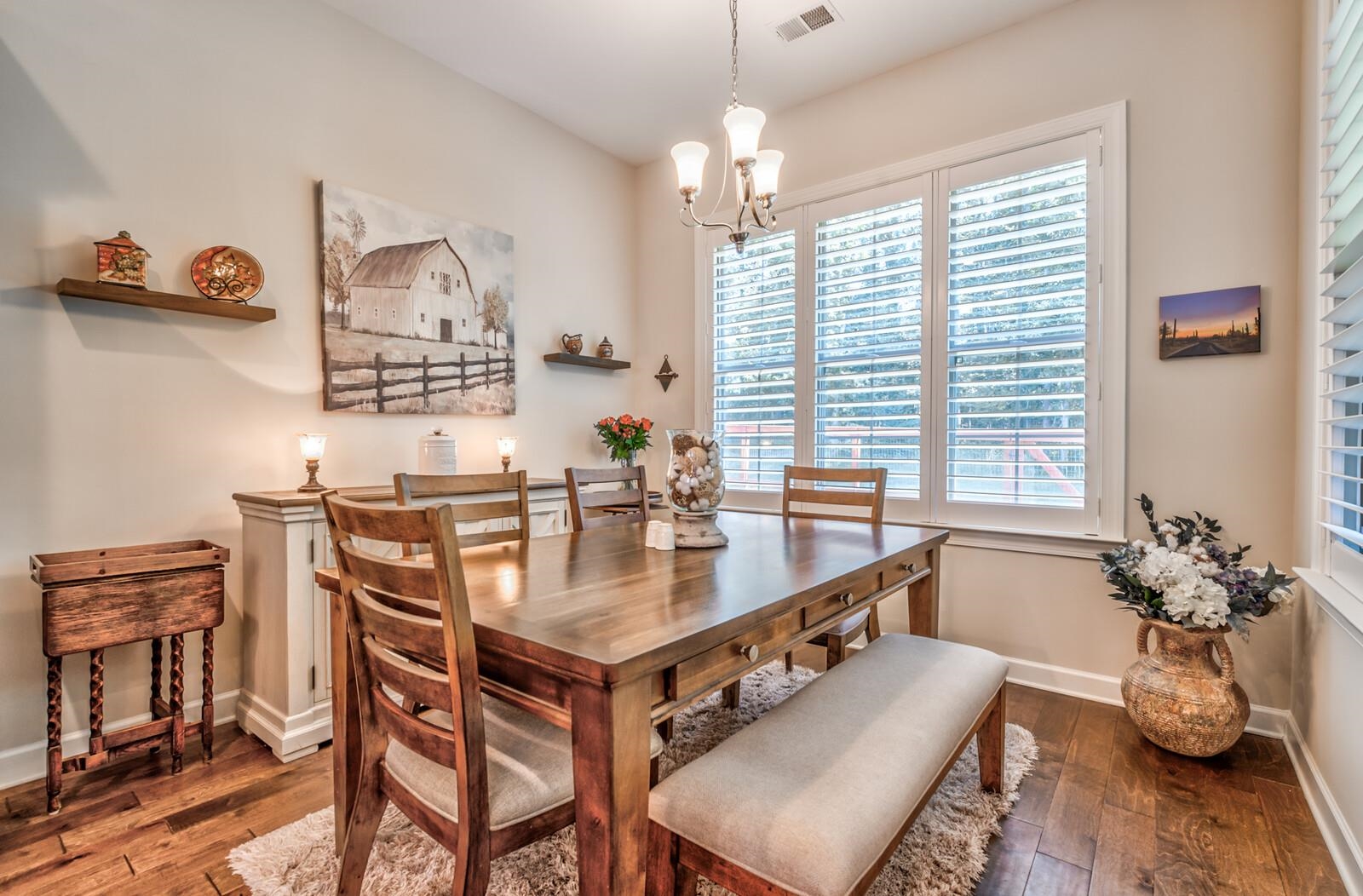 Dining room with a chandelier, dark hardwood / wood-style floors, and a wealth of natural light