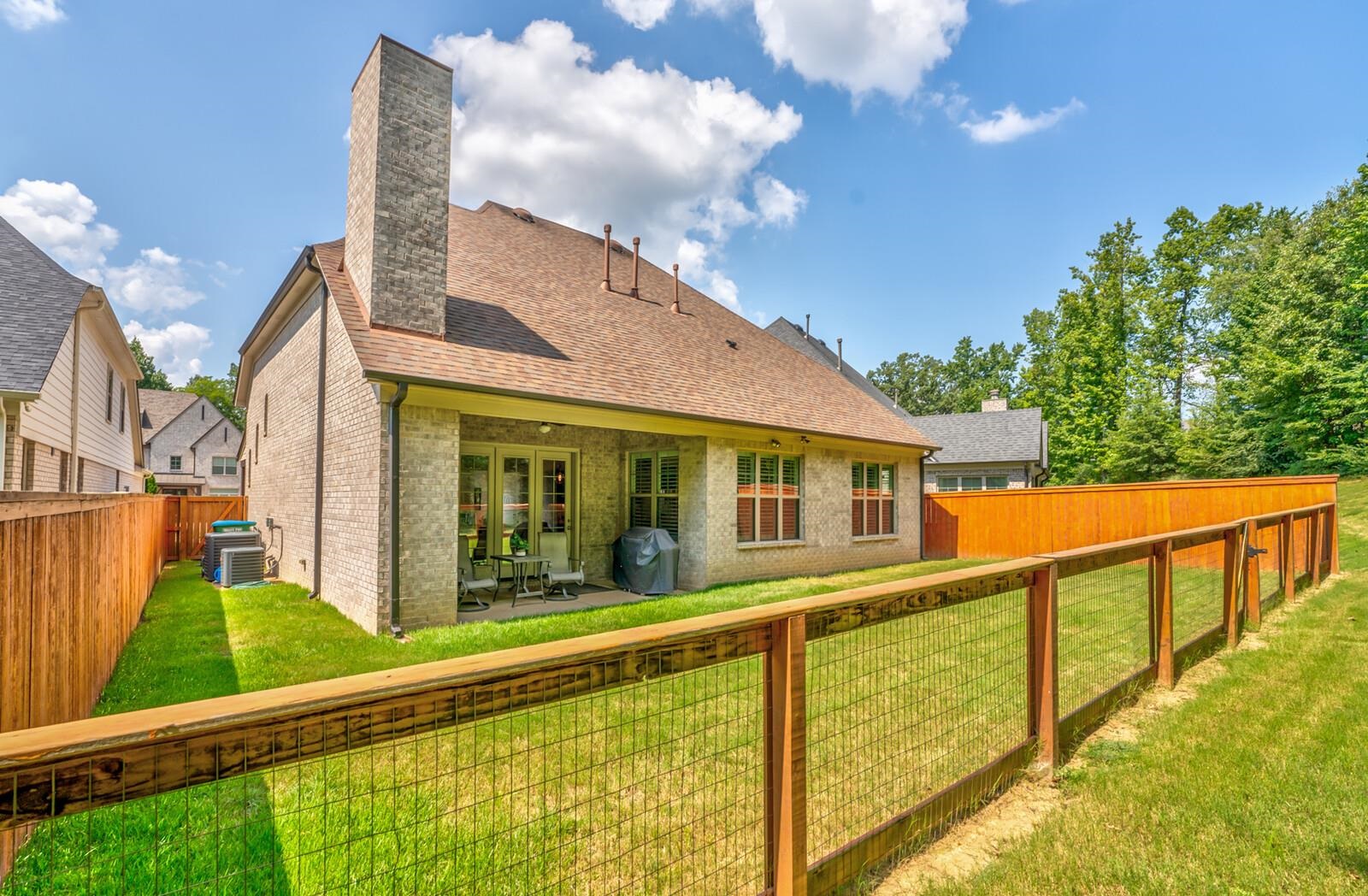 Back of house featuring a patio and a lawn