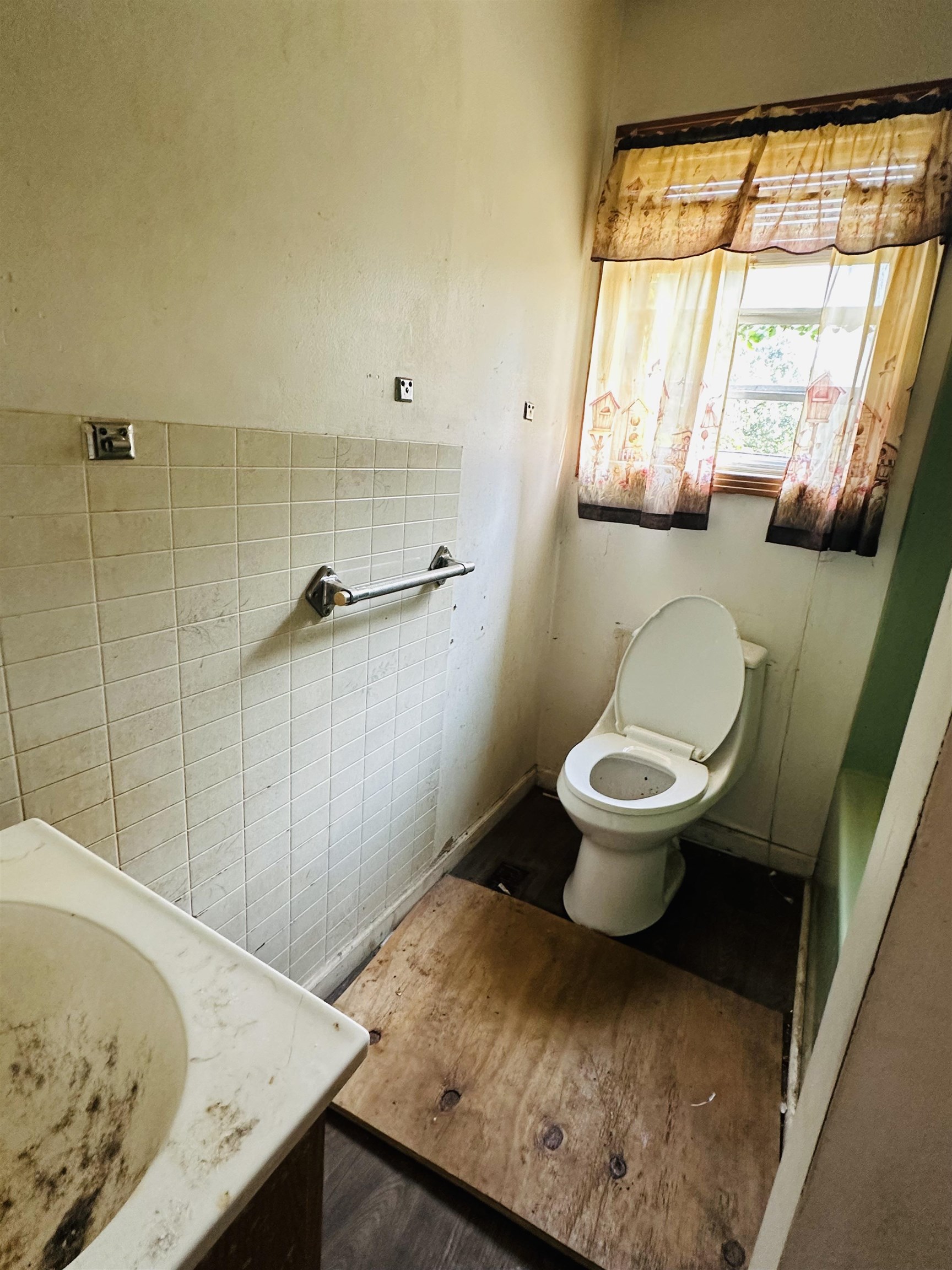 Bathroom featuring hardwood / wood-style floors and toilet