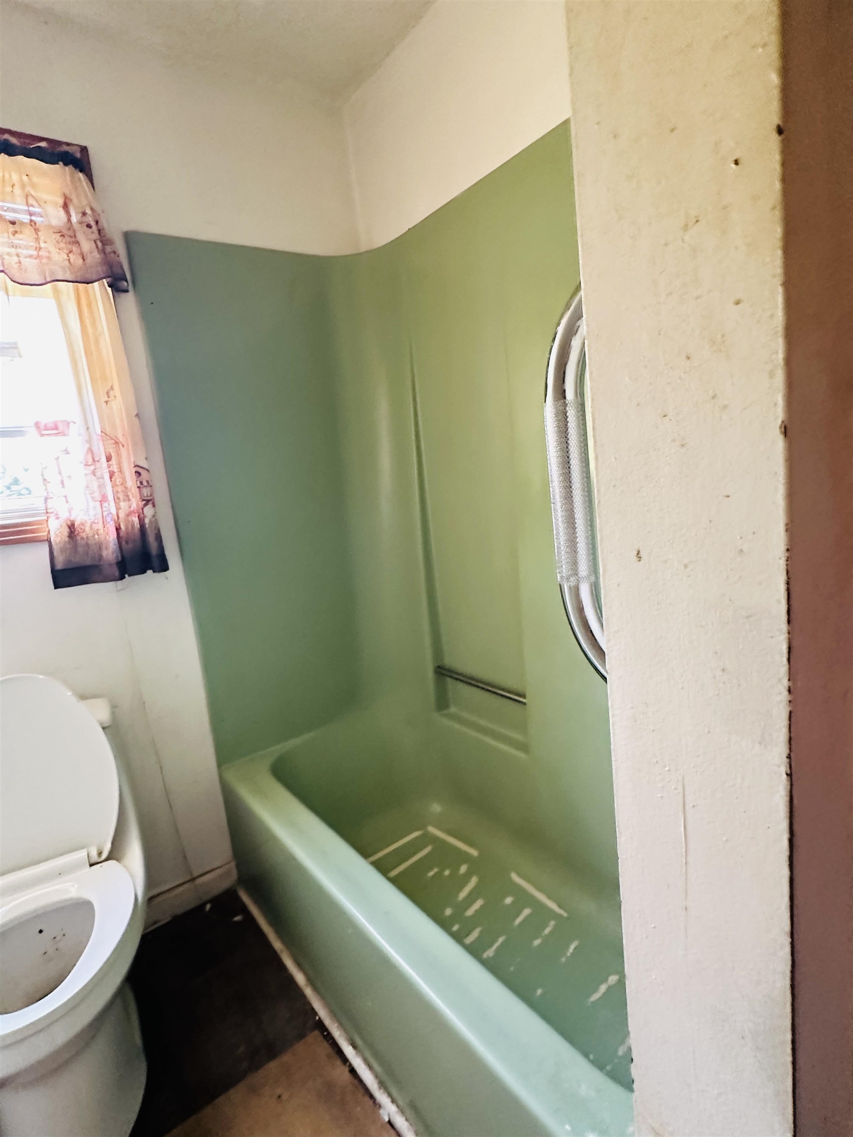 Bathroom featuring shower / washtub combination and toilet