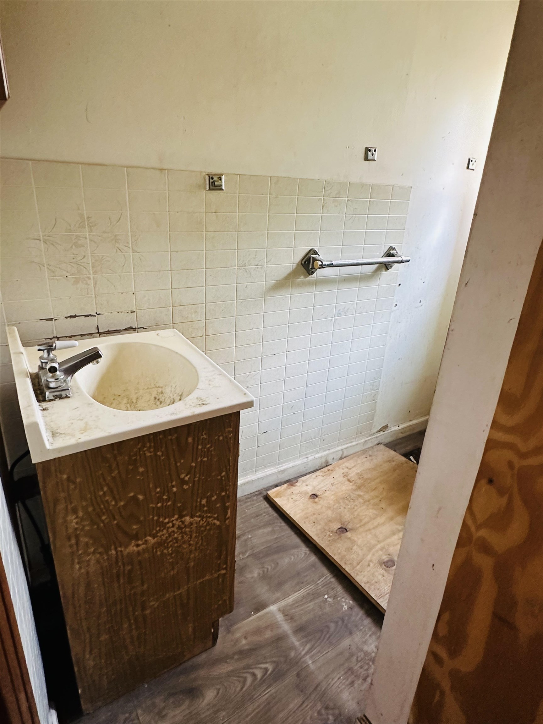 Bathroom featuring tile walls, vanity, and hardwood / wood-style flooring