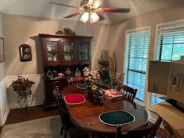 Dining area with ceiling fan, a wealth of natural light, and hardwood / wood-style flooring