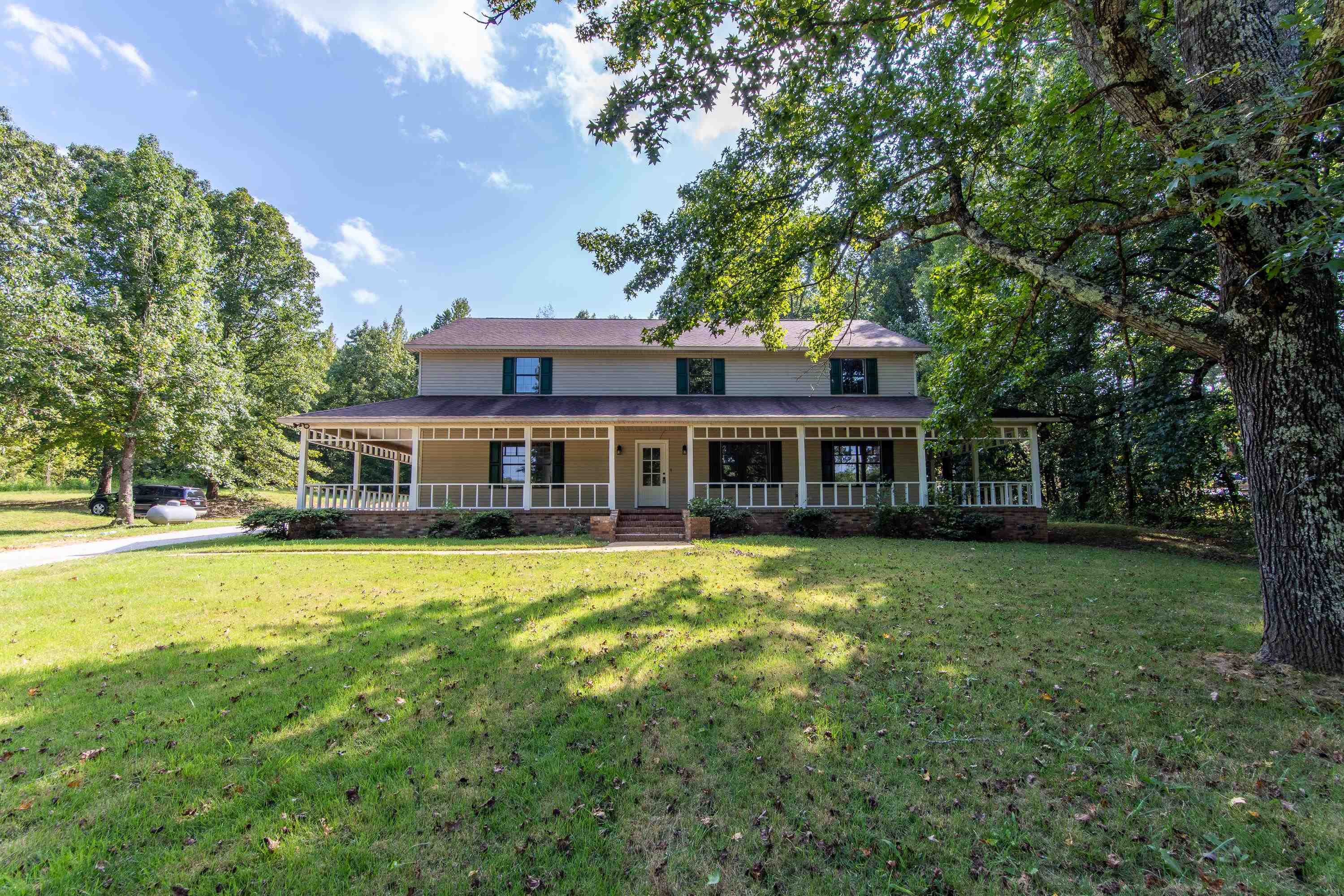 Exterior space with covered porch and a front yard