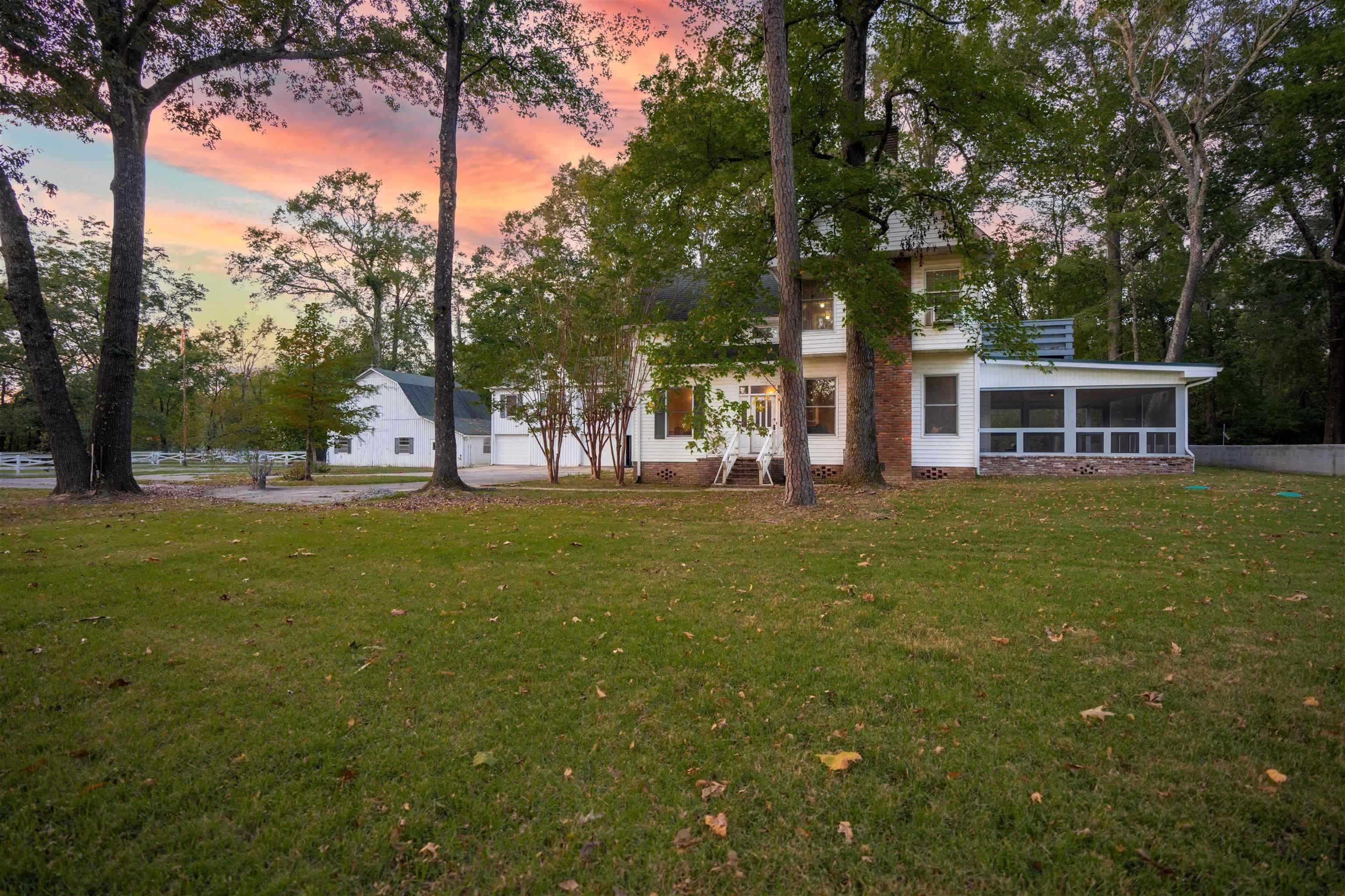 Yard at dusk with a sunroom