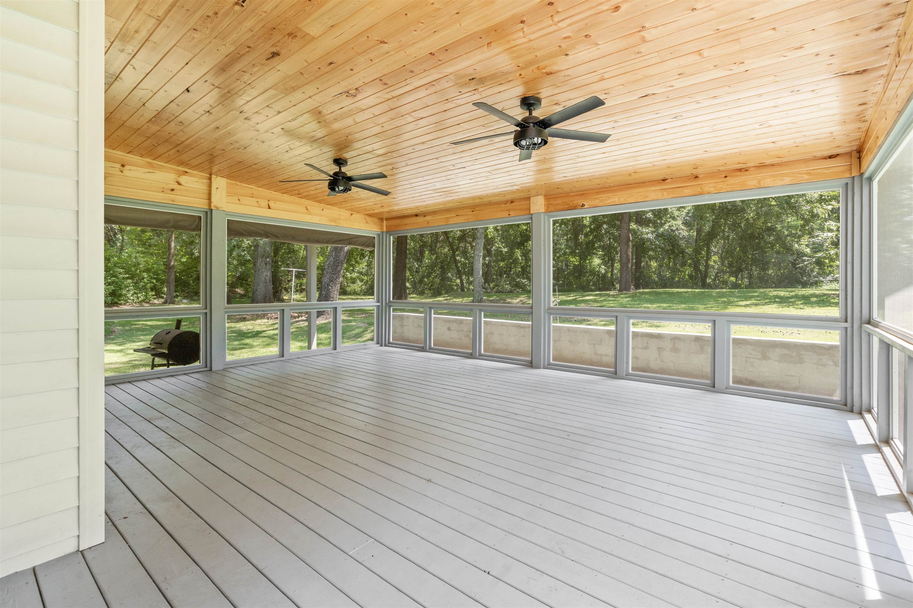 Exterior space featuring wooden ceiling, ceiling fan, and a healthy amount of sunlight
