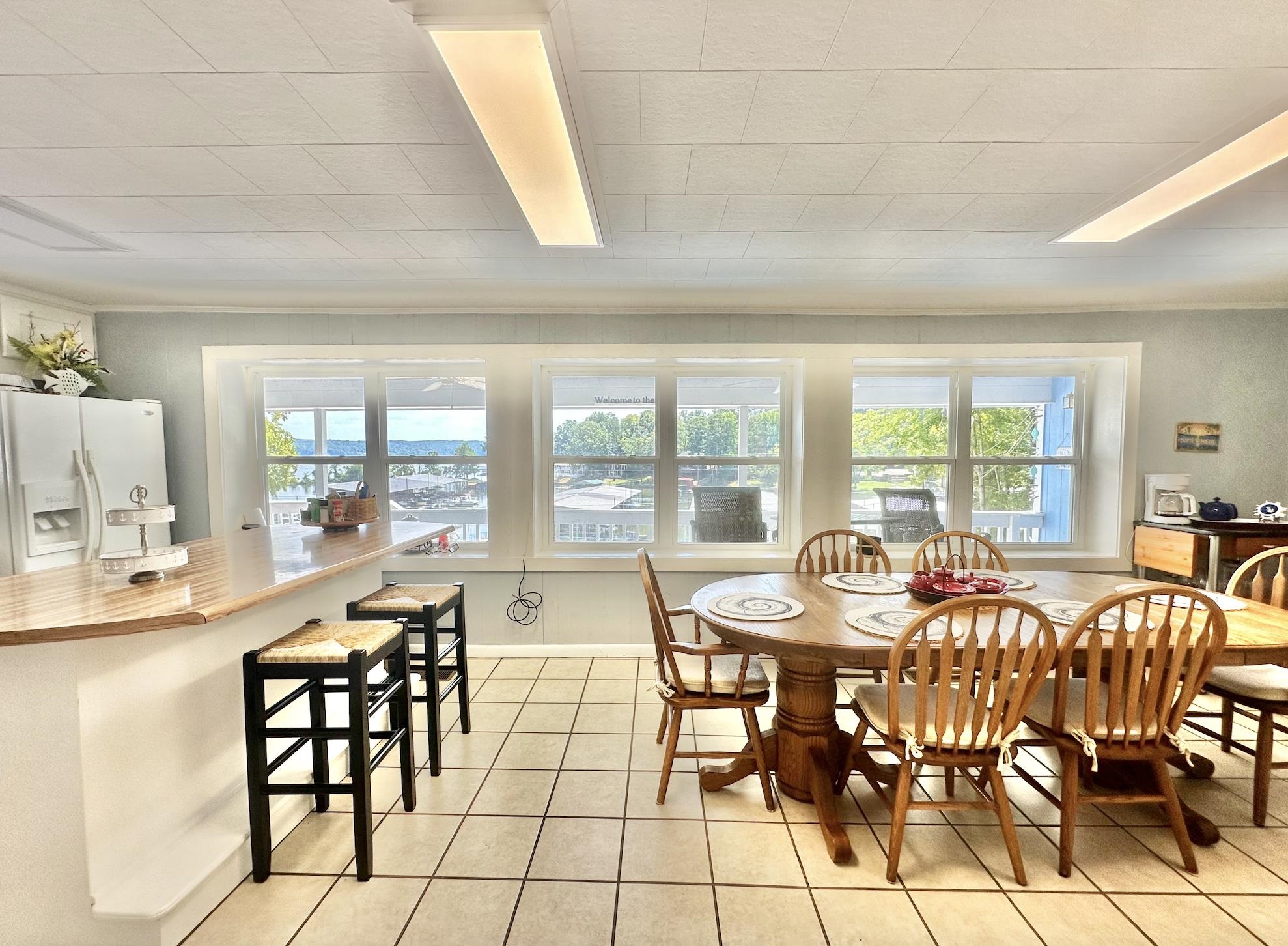 Tiled dining area featuring a wealth of natural light