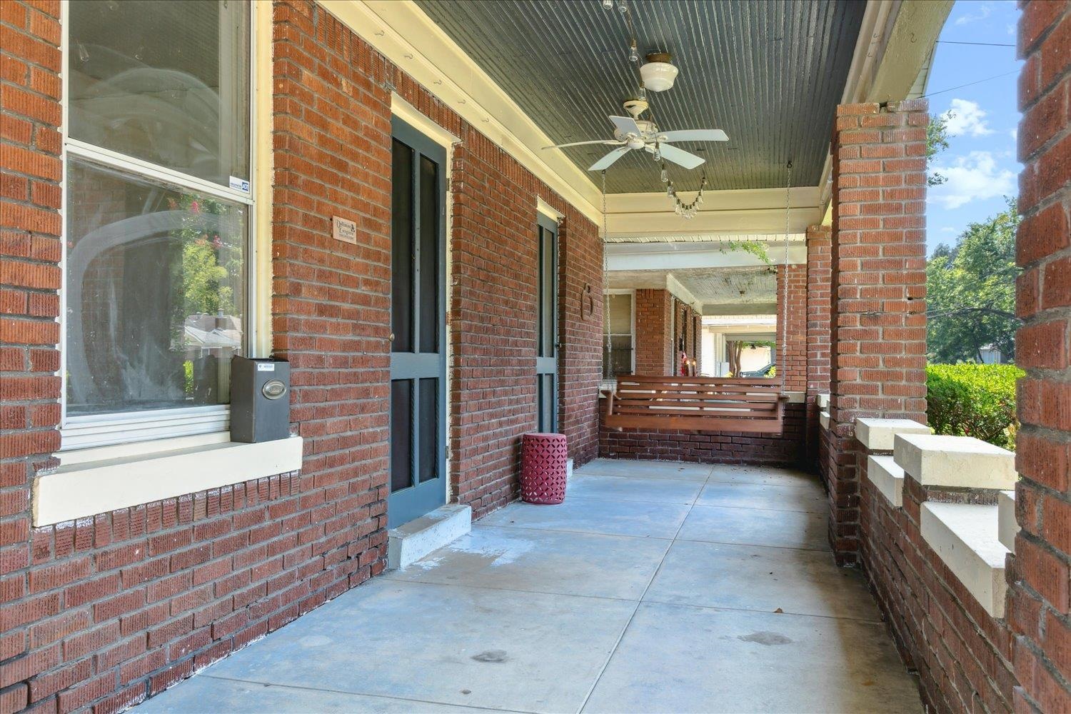 View of patio with ceiling fan and covered porch