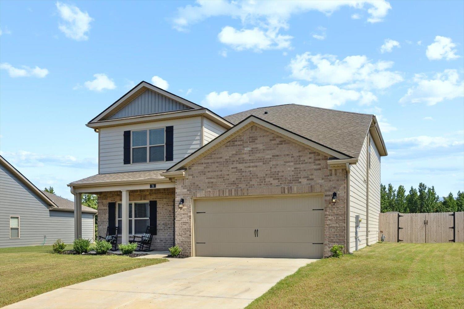 Craftsman house with a garage and a front lawn