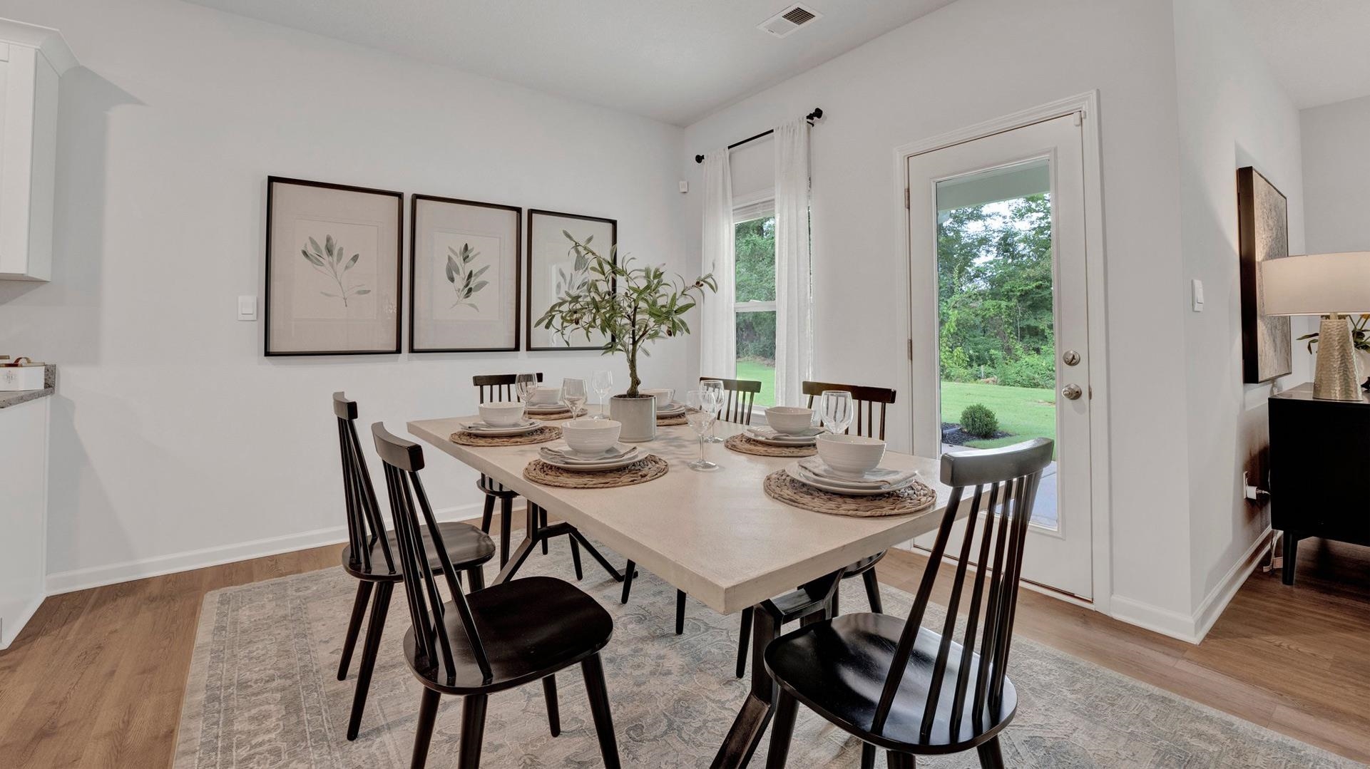 Dining space with light hardwood / wood-style flooring