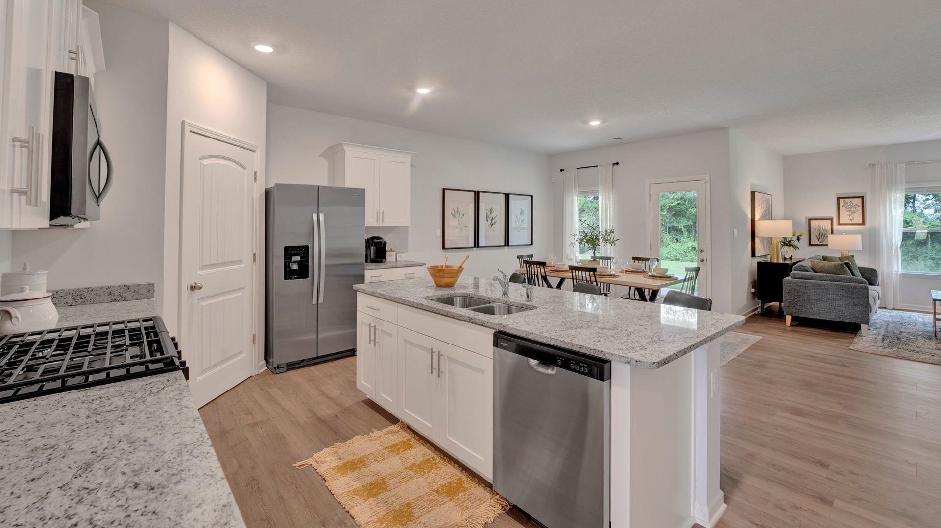 Kitchen featuring a wealth of natural light, appliances with stainless steel finishes, sink, and light hardwood / wood-style floors