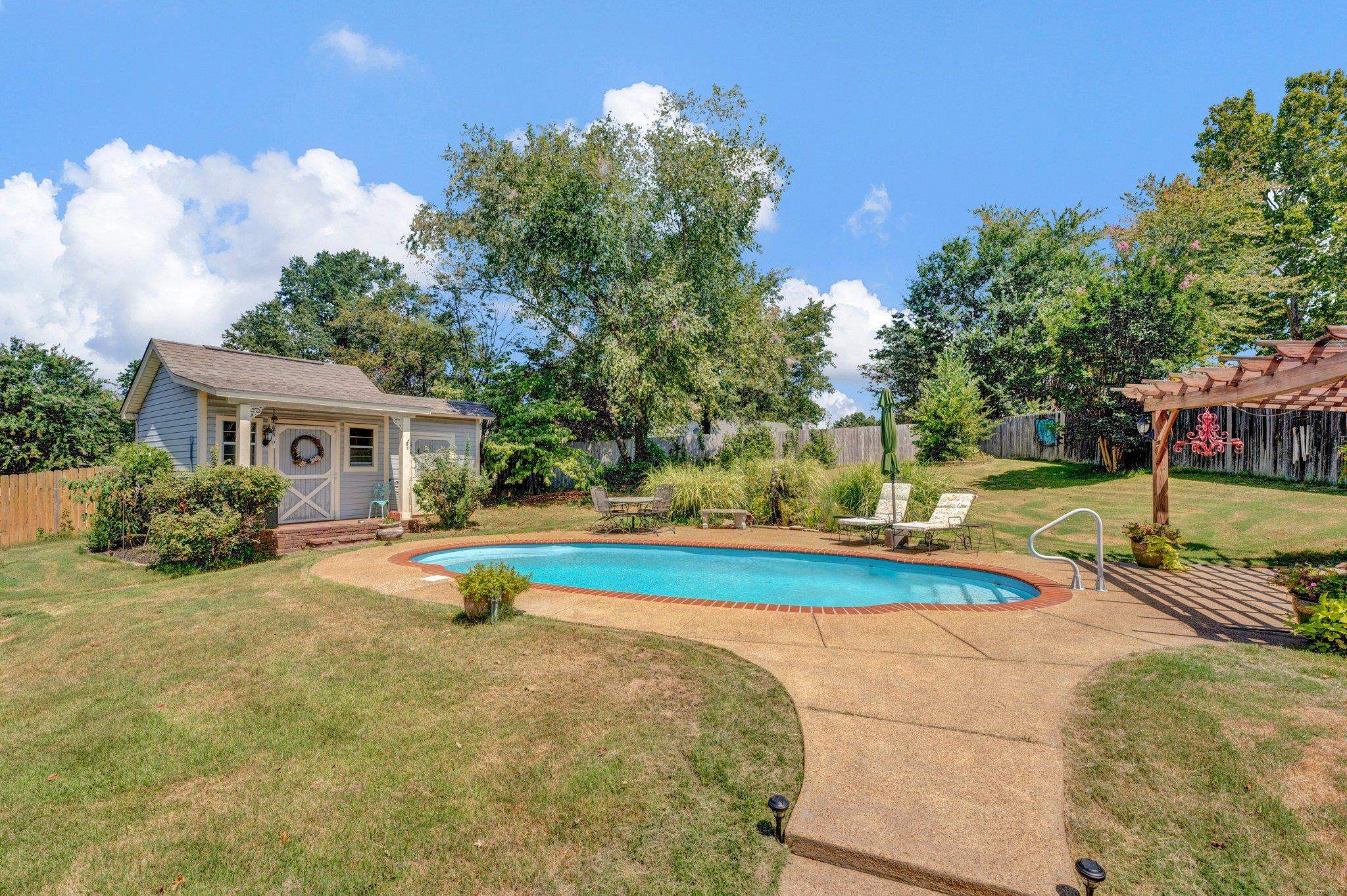 View of swimming pool with a pergola, a patio, and a lawn