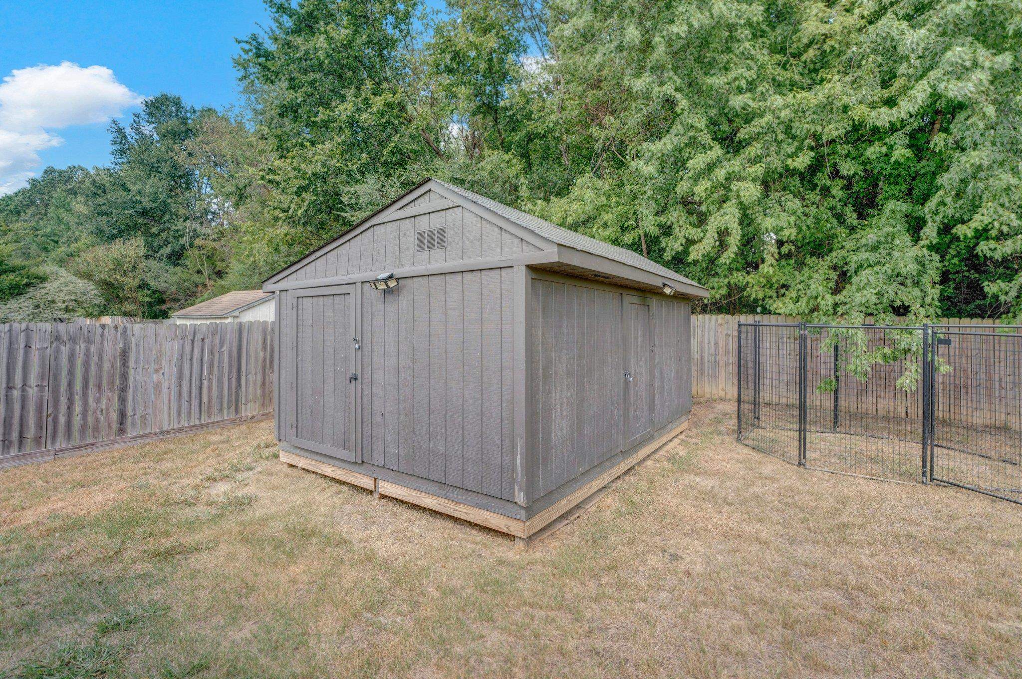 View of outdoor structure featuring a yard