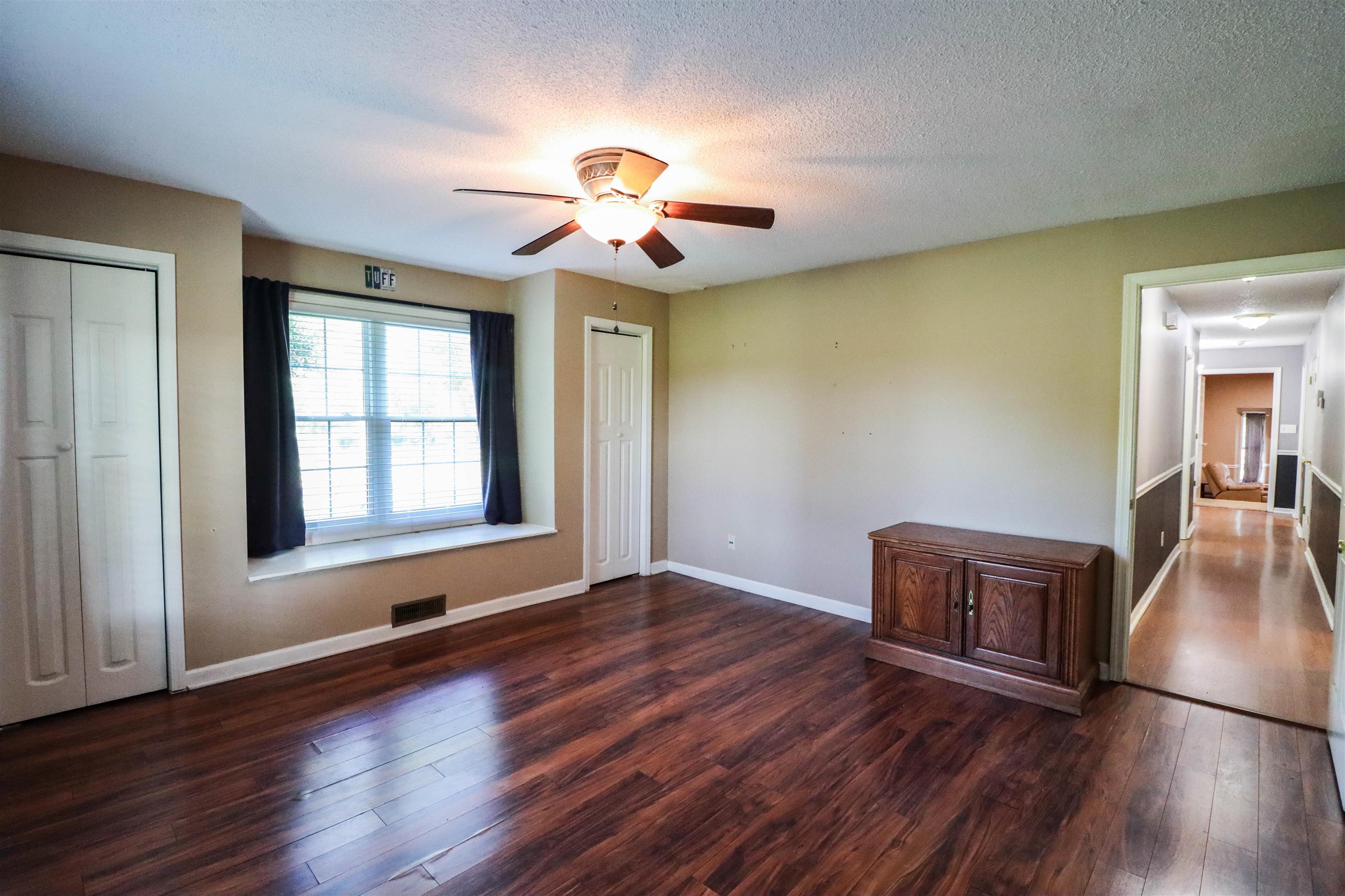 Unfurnished room with a textured ceiling, ceiling fan, and hardwood / wood-style floors