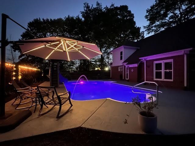 View of pool featuring a patio and pool water feature