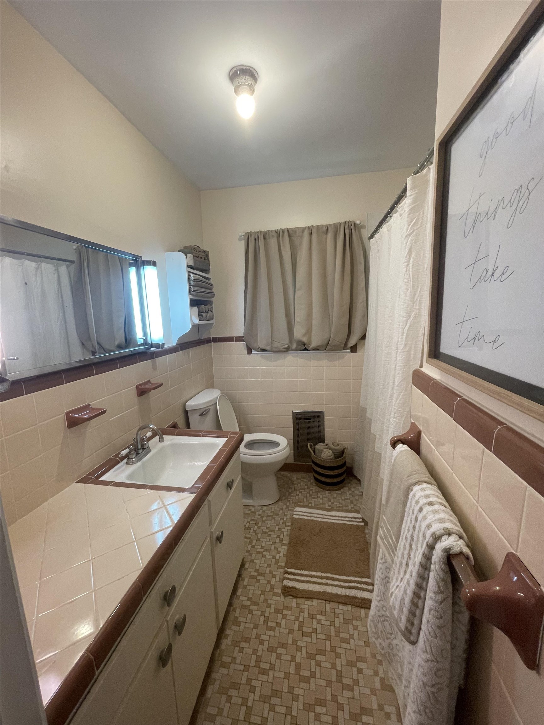 Bathroom featuring vanity, tile patterned flooring, toilet, and tile walls