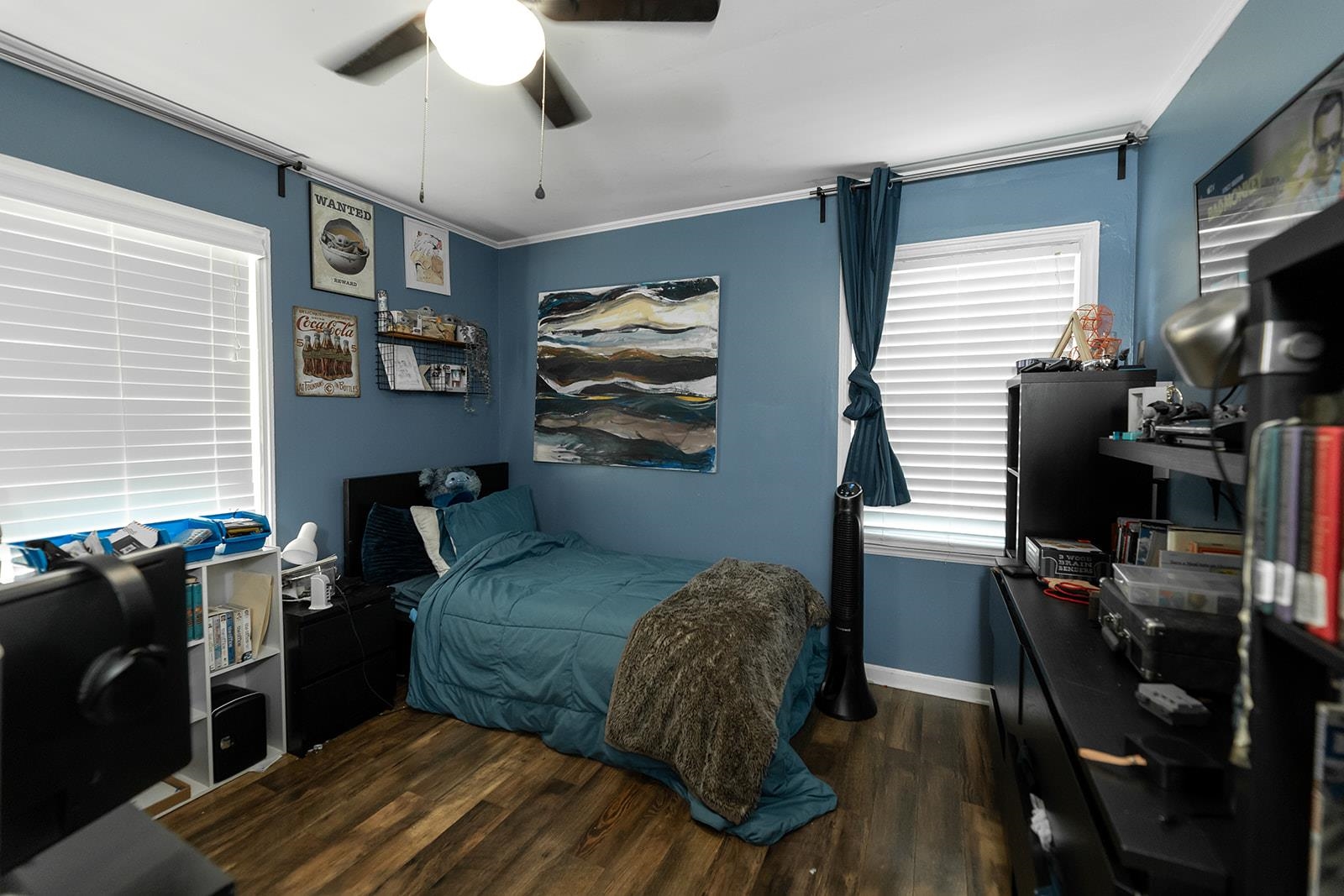 Bedroom featuring ceiling fan, multiple windows, dark hardwood / wood-style flooring, and ornamental molding