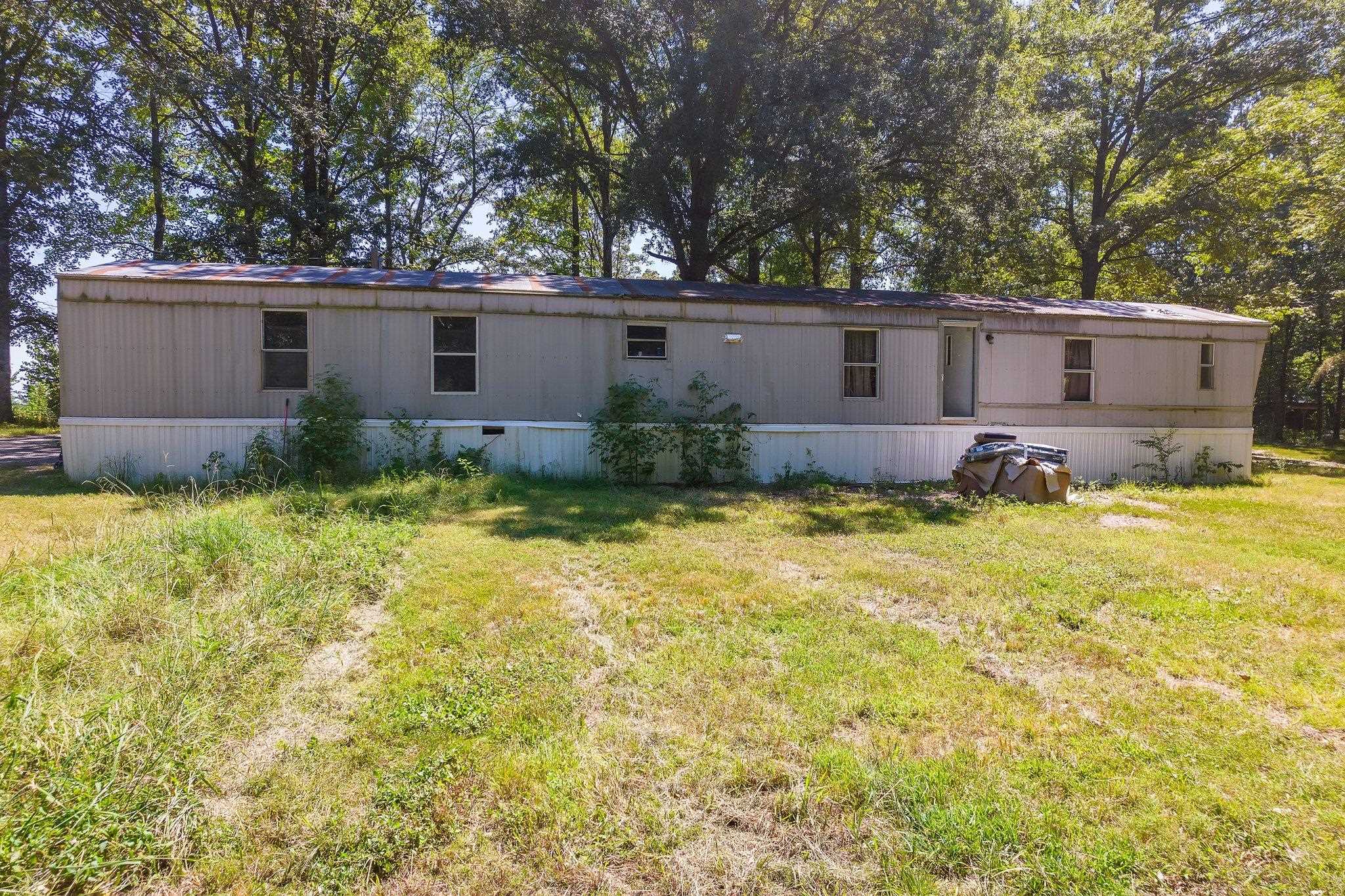 Rear view of house featuring a lawn