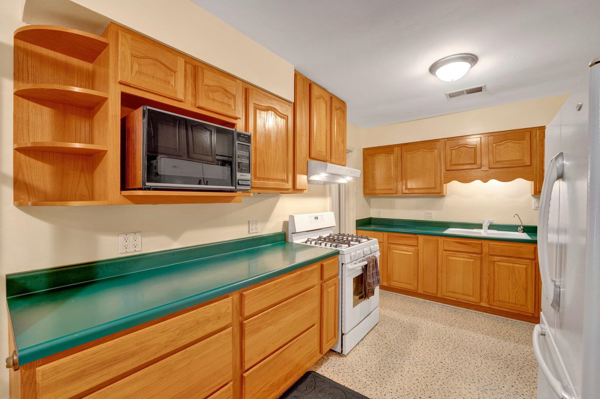 Kitchen featuring sink and white appliances