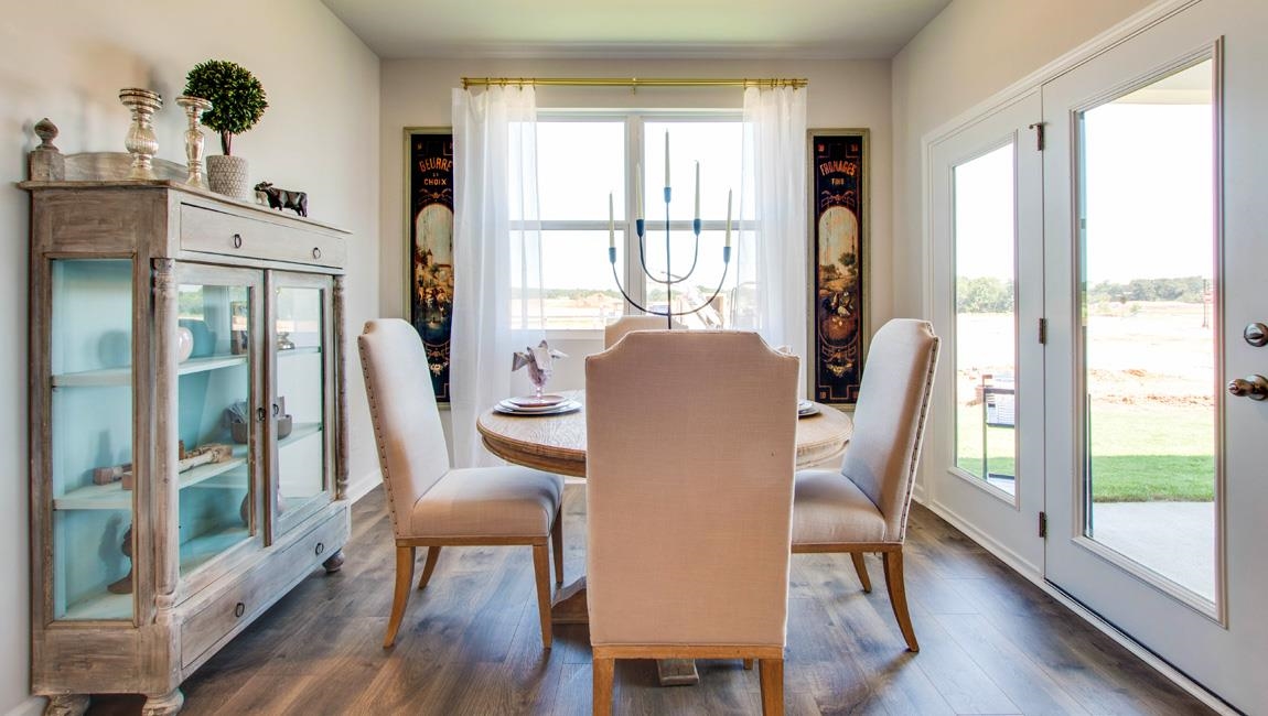 Dining room with dark hardwood / wood-style floors and french doors