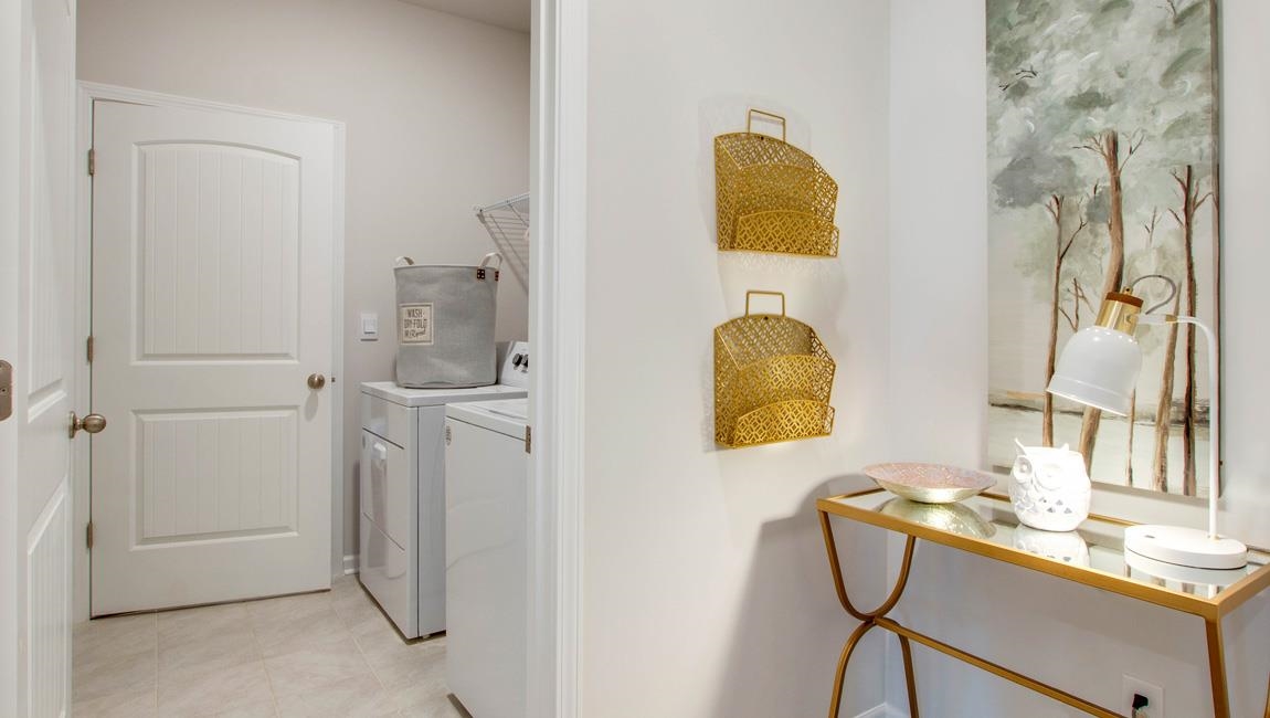 Laundry area with light tile patterned floors and separate washer and dryer