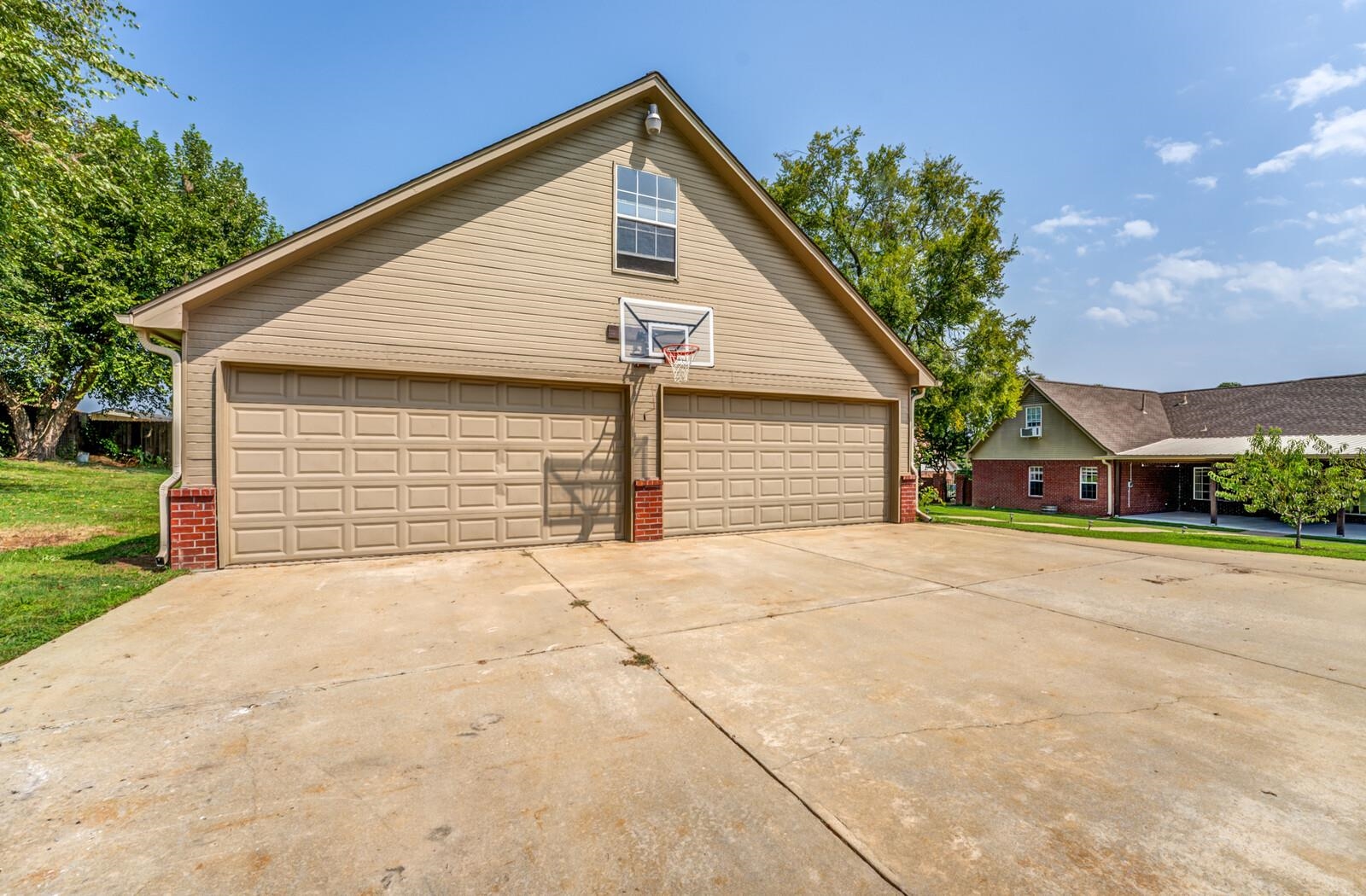 View of side of property with a garage