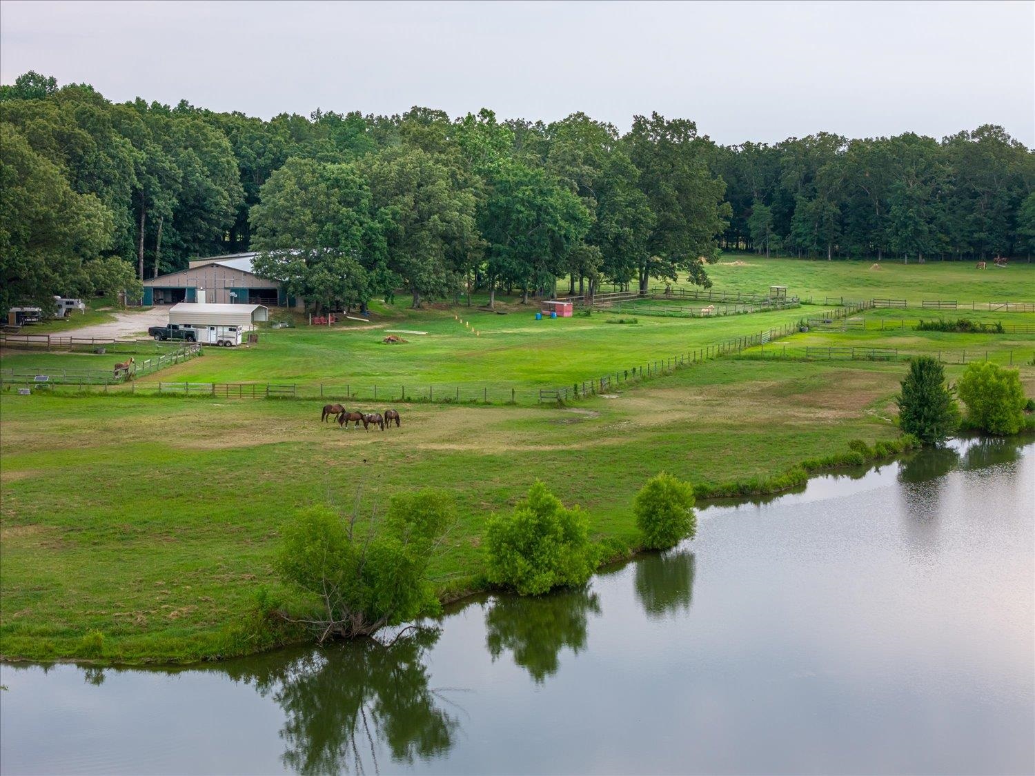 Surrounding community with a rural view, a yard, and a water view
