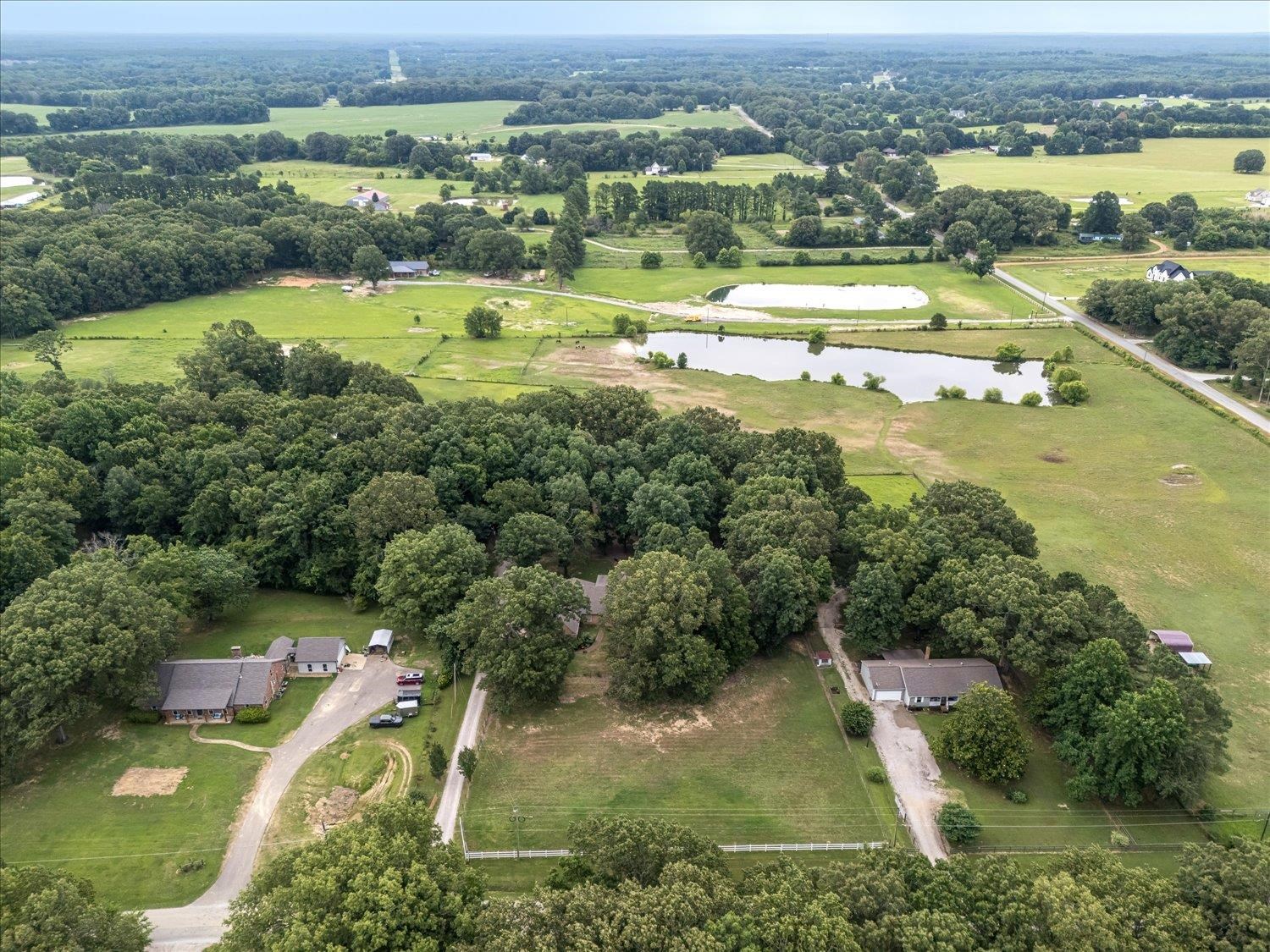 Birds eye view of property with a rural view and a water view