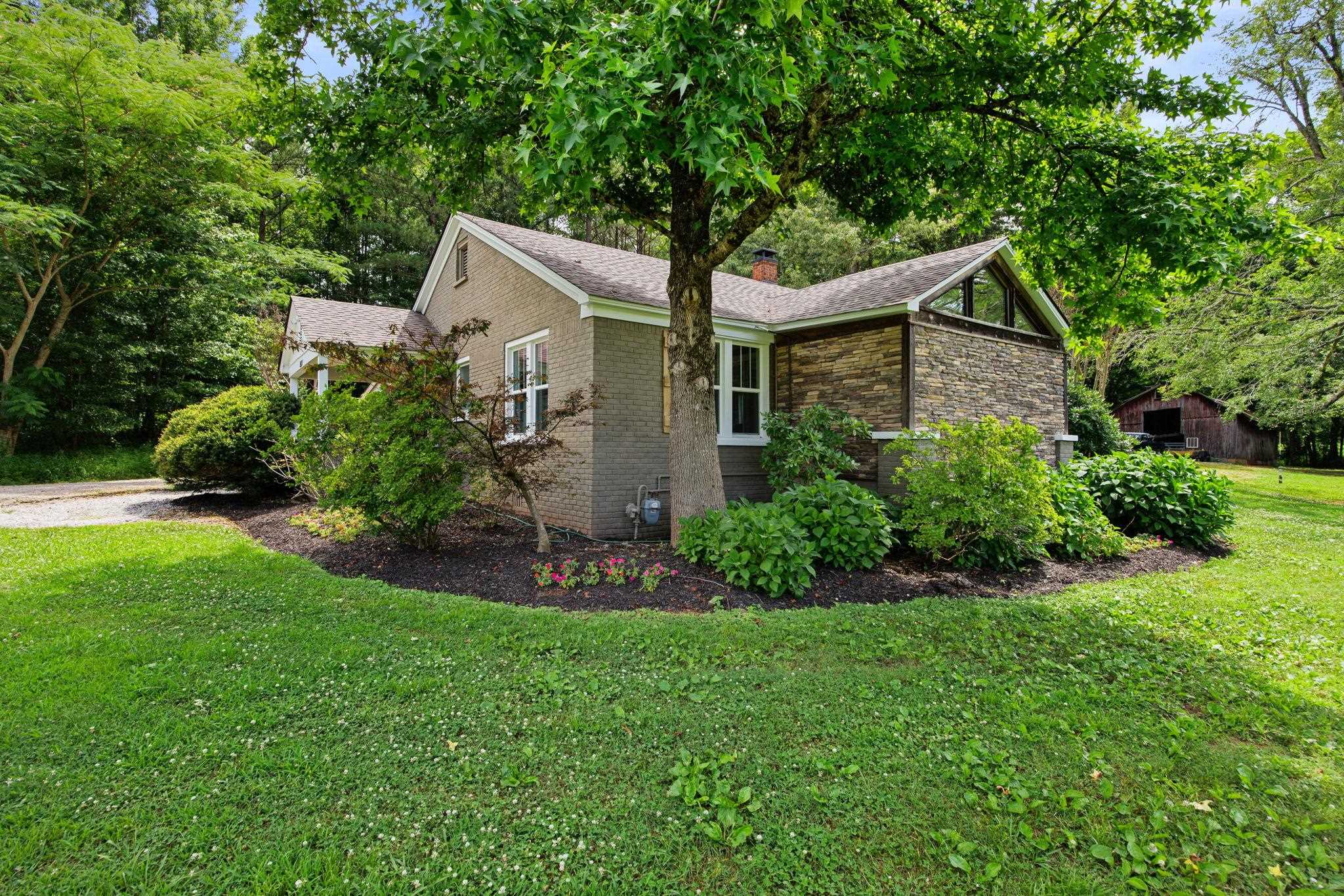 View of side of home with a yard