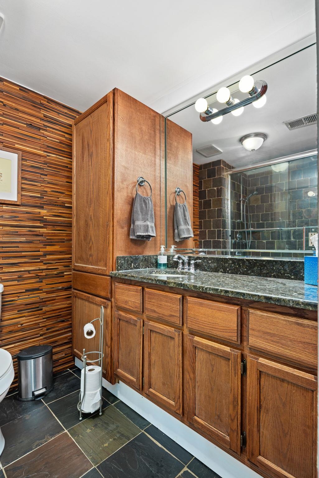 Bathroom with tile patterned flooring, toilet, and vanity