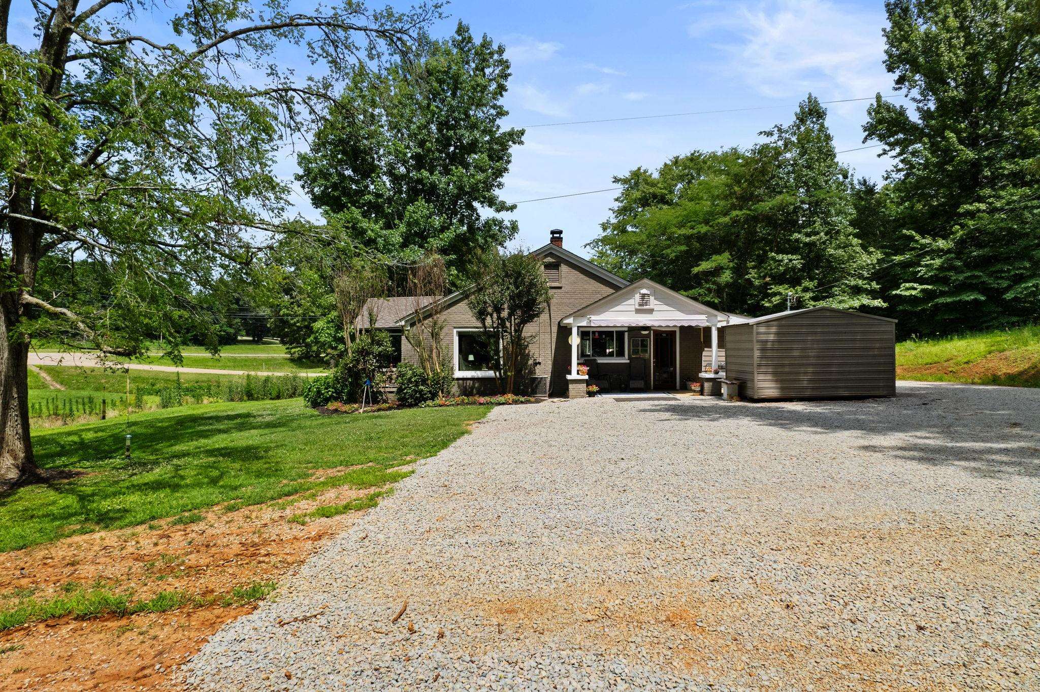 View of front of house with an outdoor structure and a front lawn