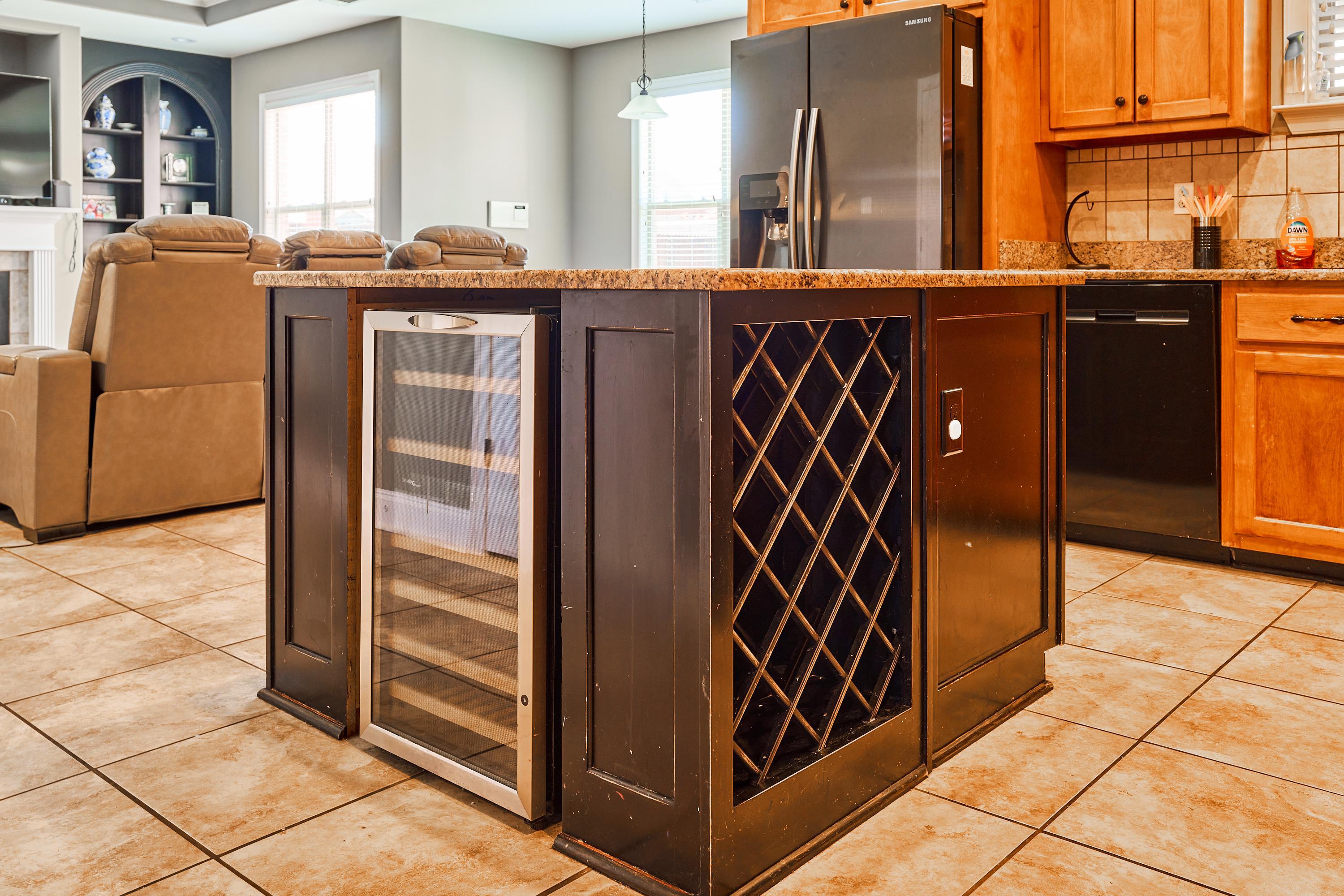 Island has wine cooler and wine rack