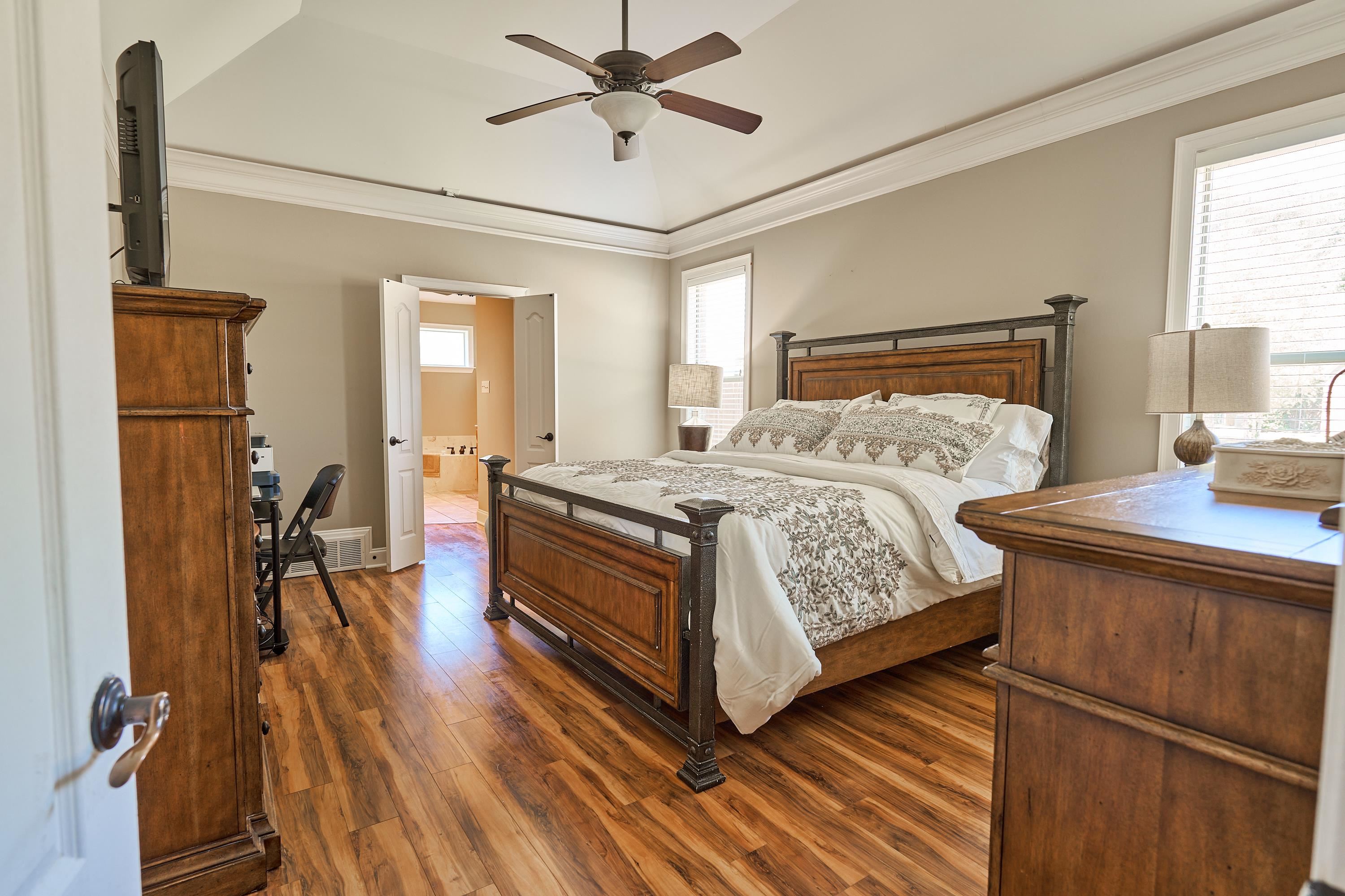 Primary Bedroom has  crown molding, beautiful  hardwood-flooring