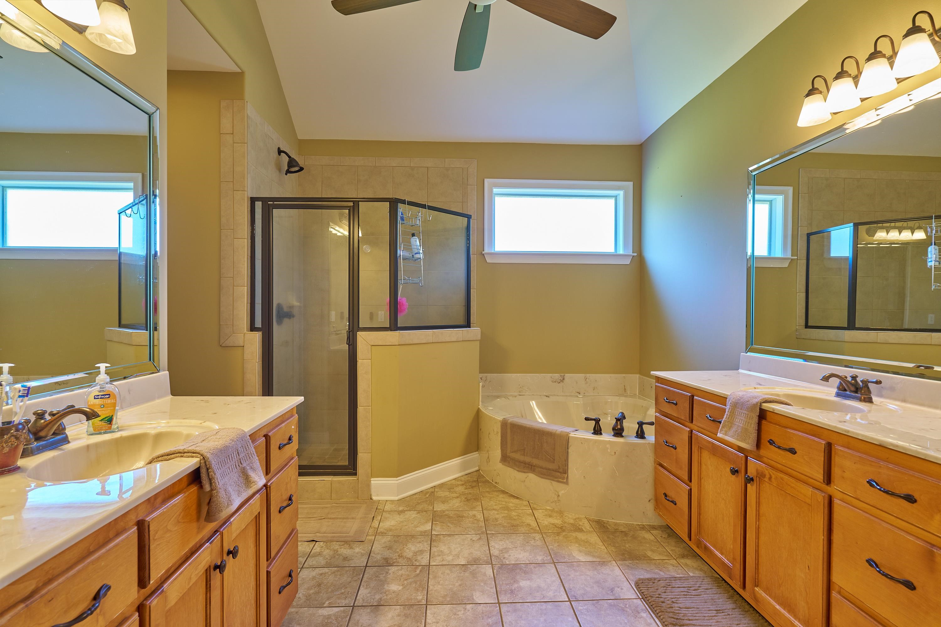 Separate Vanities Walk-In shower and Whirlpool Tub. The color is actually beige like the next piture, not a gold color.