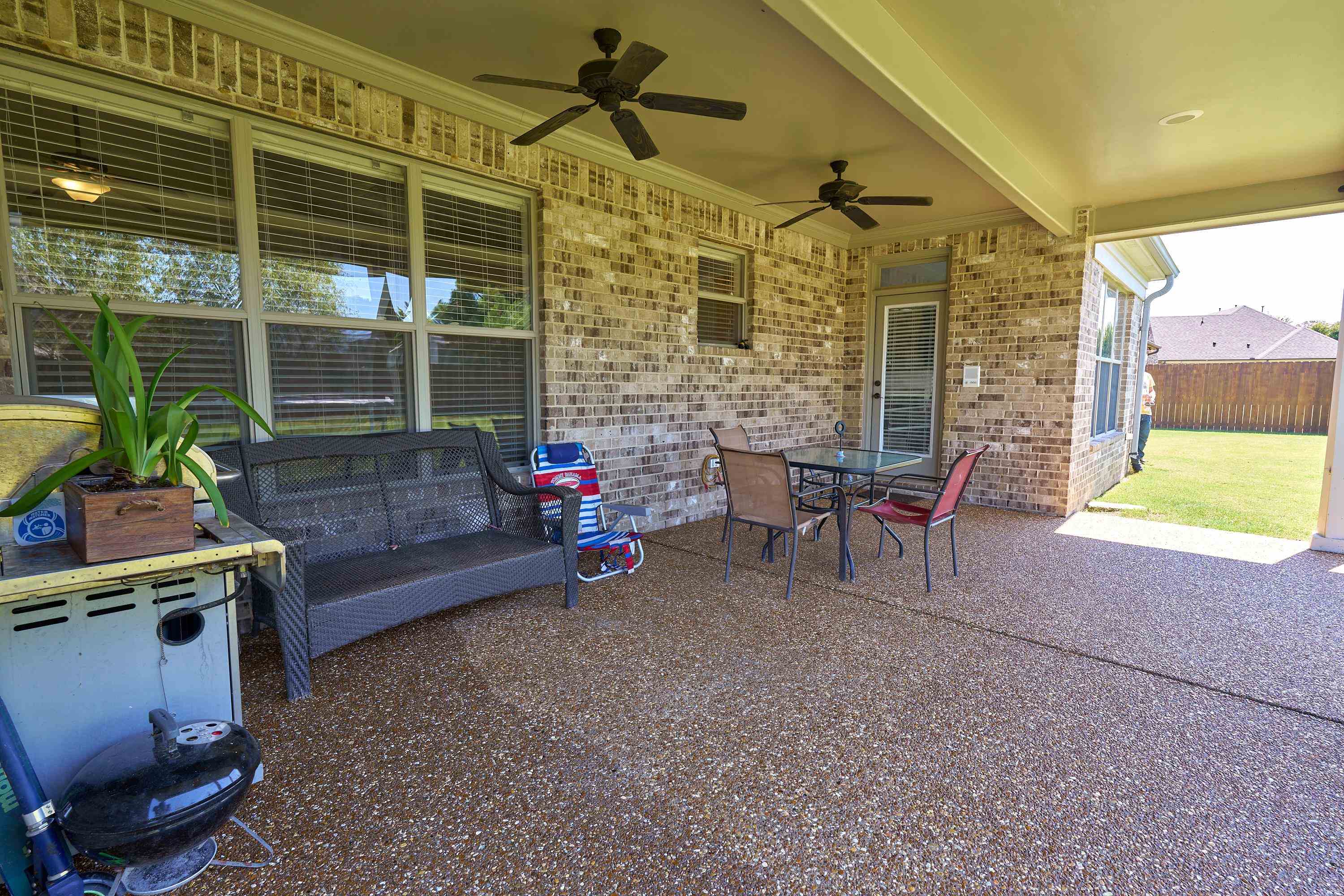 Ceiling fans on the patio make it a pleasant place to relax all year long.
