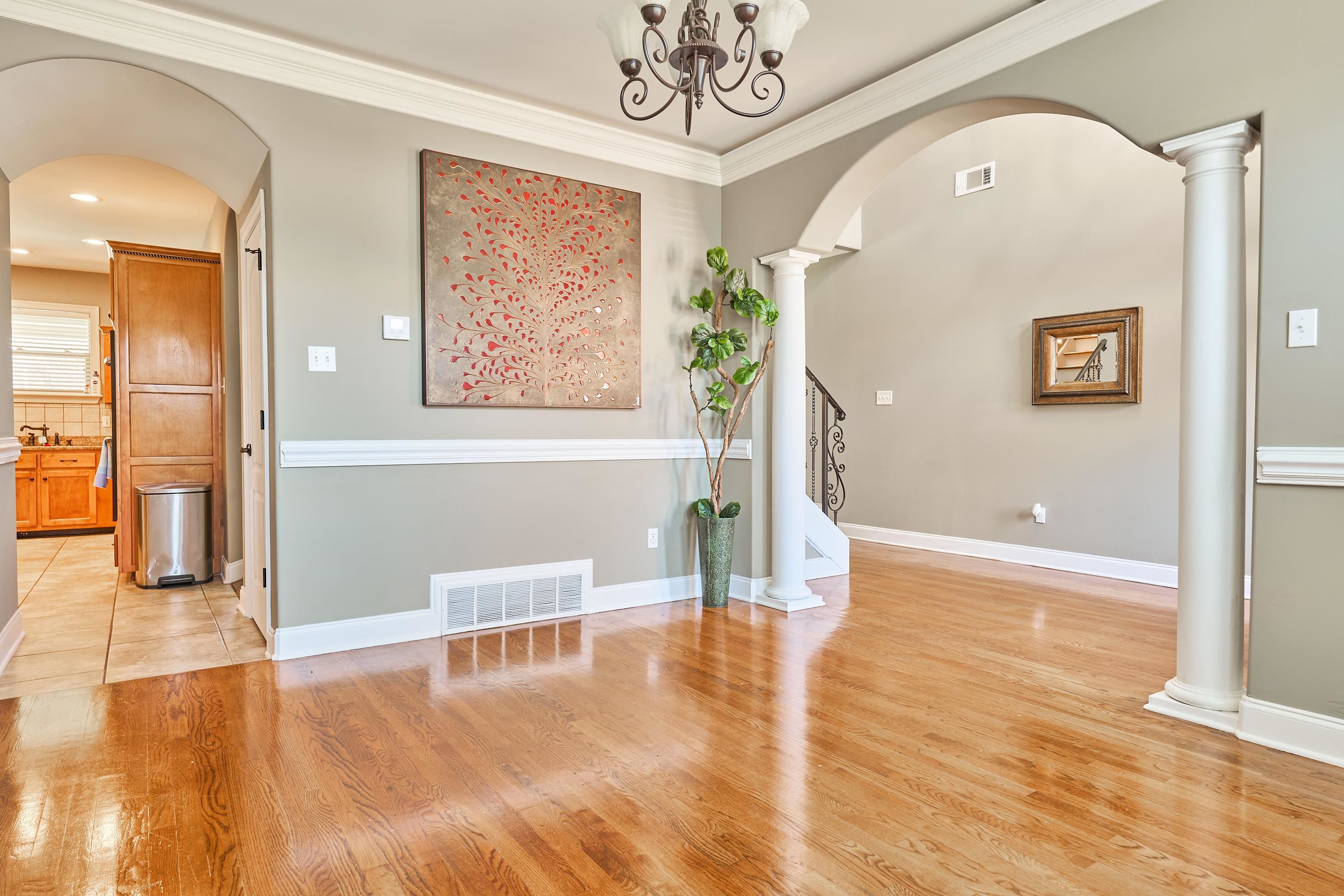 Spacious Dining room has decorative columns & crown molding,