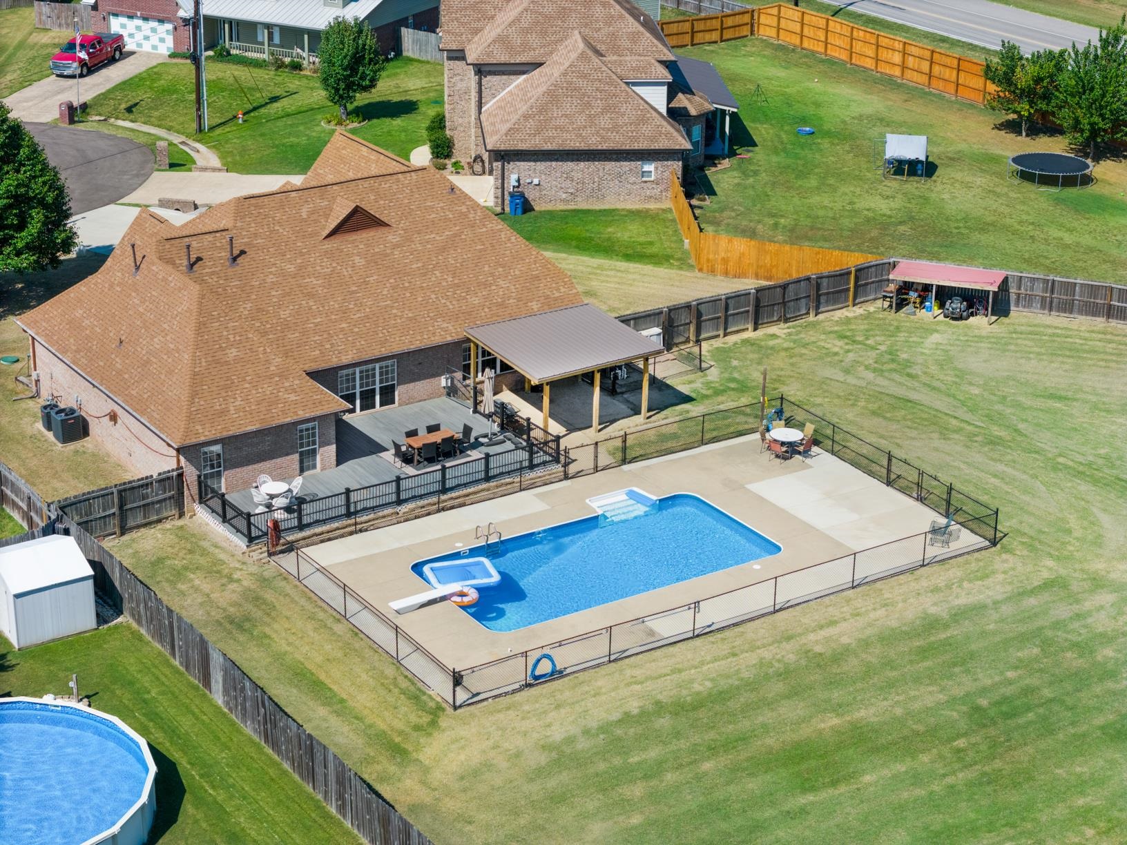 View of swimming pool with a yard, a diving board, and a patio area