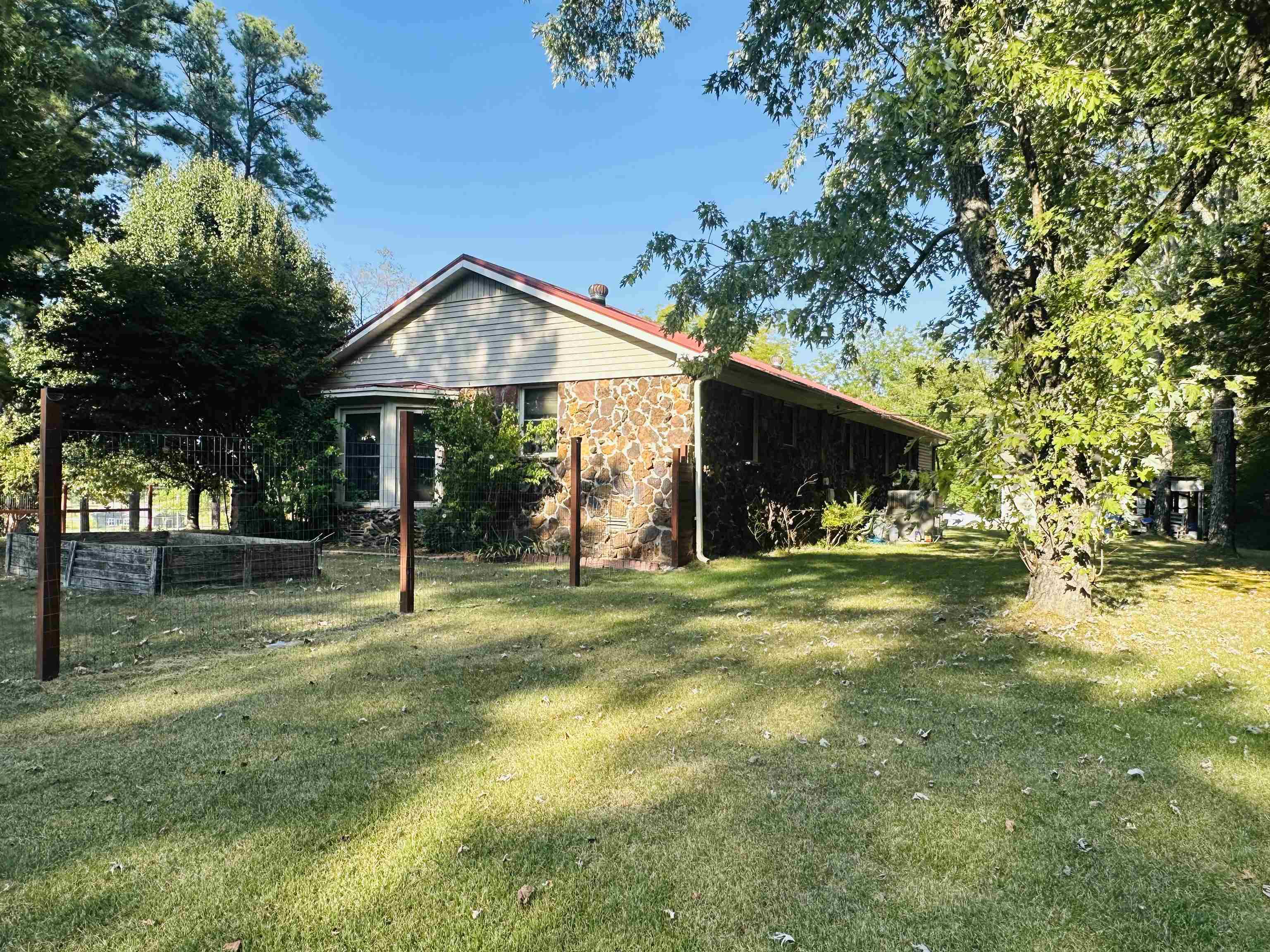 View of side of home with a yard