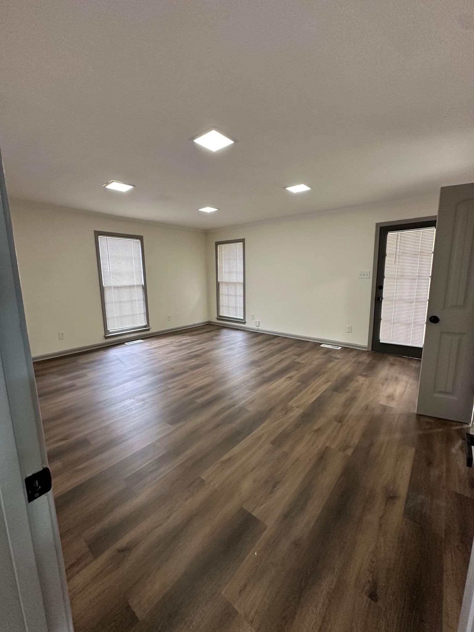 Spare room with dark hardwood / wood-style floors