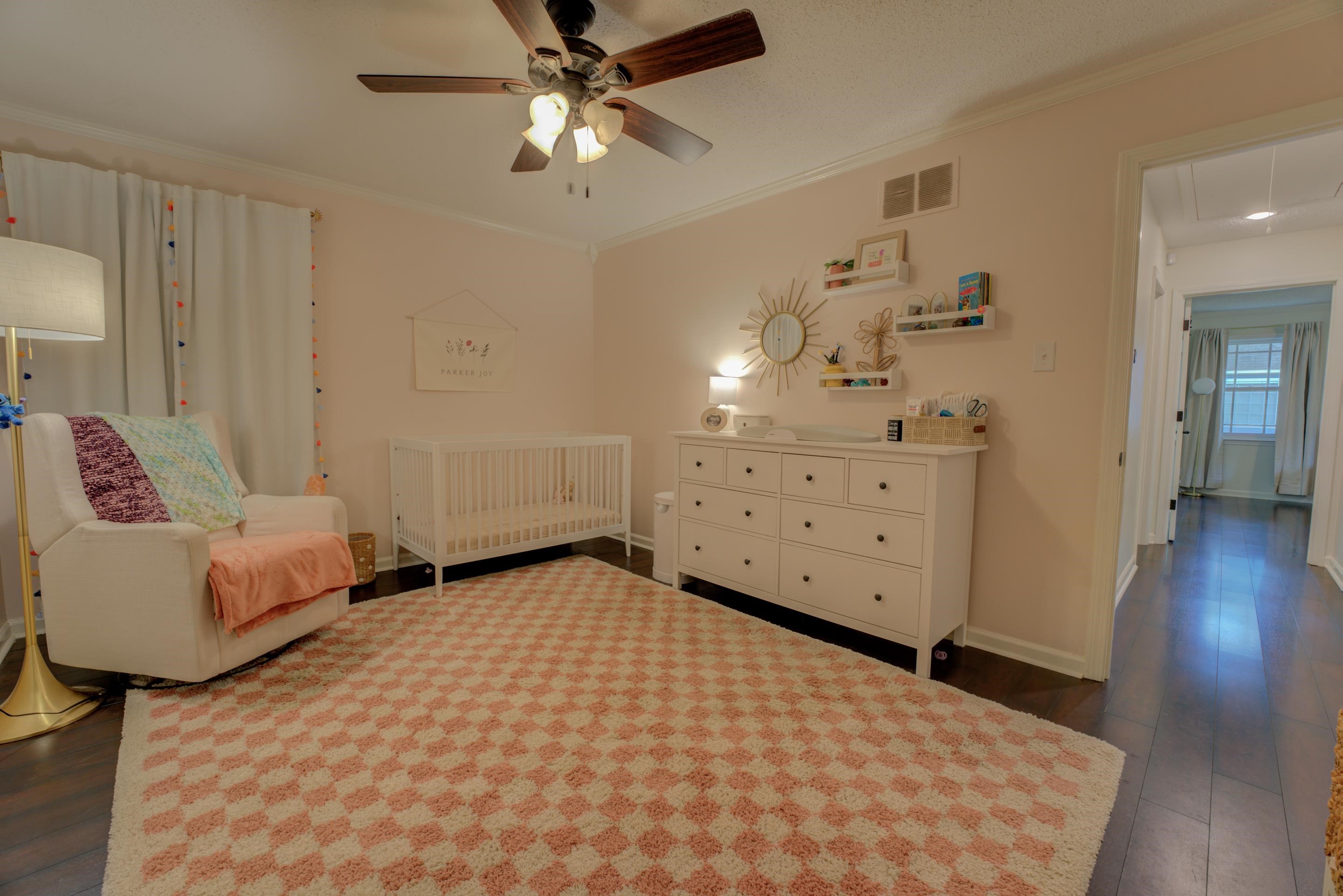 Bedroom featuring ornamental molding, ceiling fan, and dark hardwood / wood-style floors