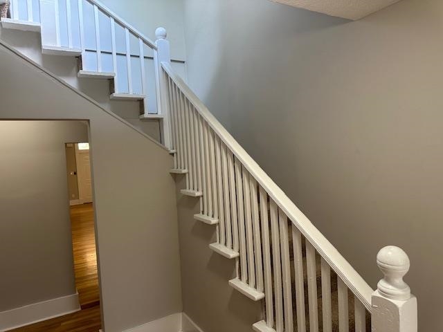 Staircase with hardwood / wood-style flooring