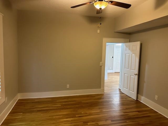 Spare room featuring ceiling fan and wood-type flooring