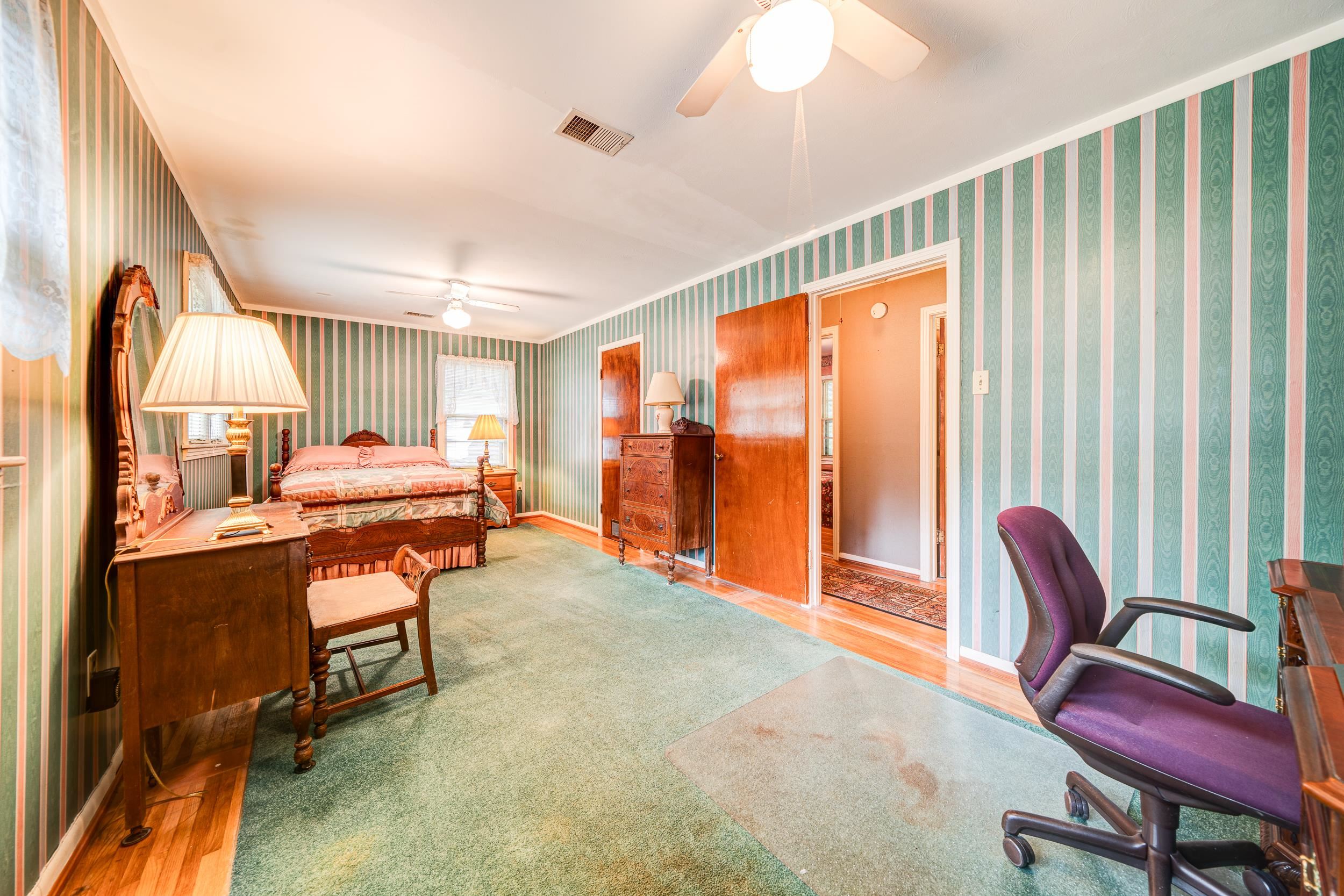 Bedroom with hardwood / wood-style floors and ceiling fan