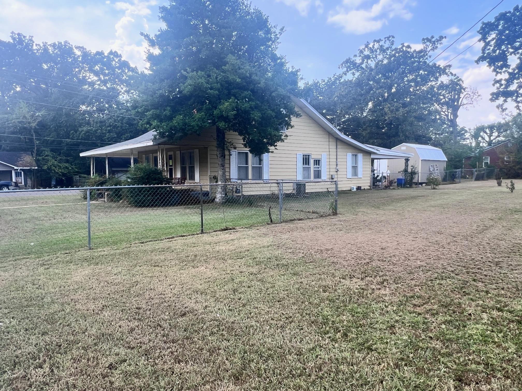 View of side of property featuring a lawn