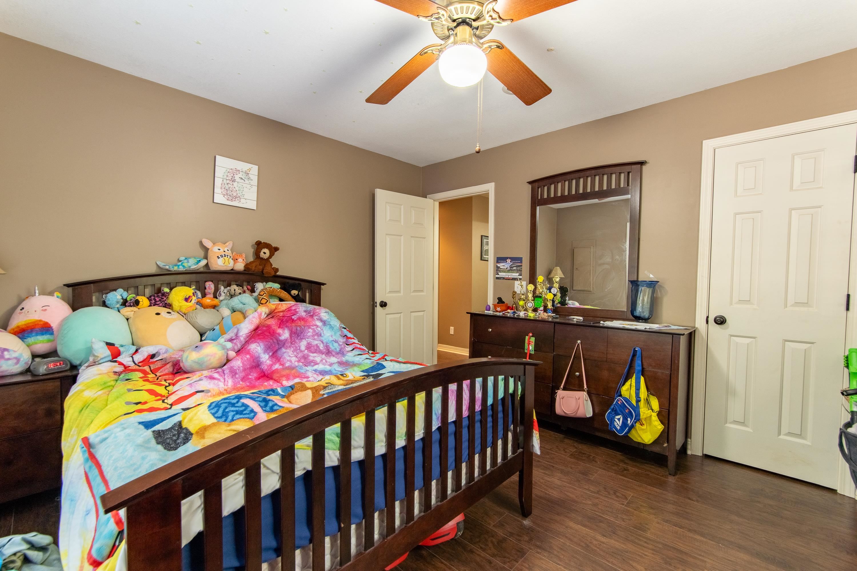 Bedroom with ceiling fan and dark hardwood / wood-style flooring