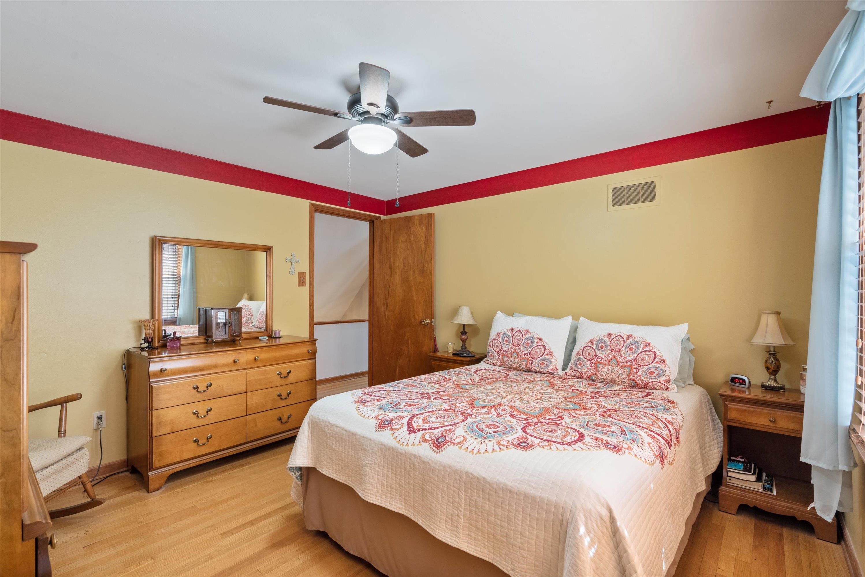 Bedroom featuring ceiling fan and light hardwood / wood-style flooring